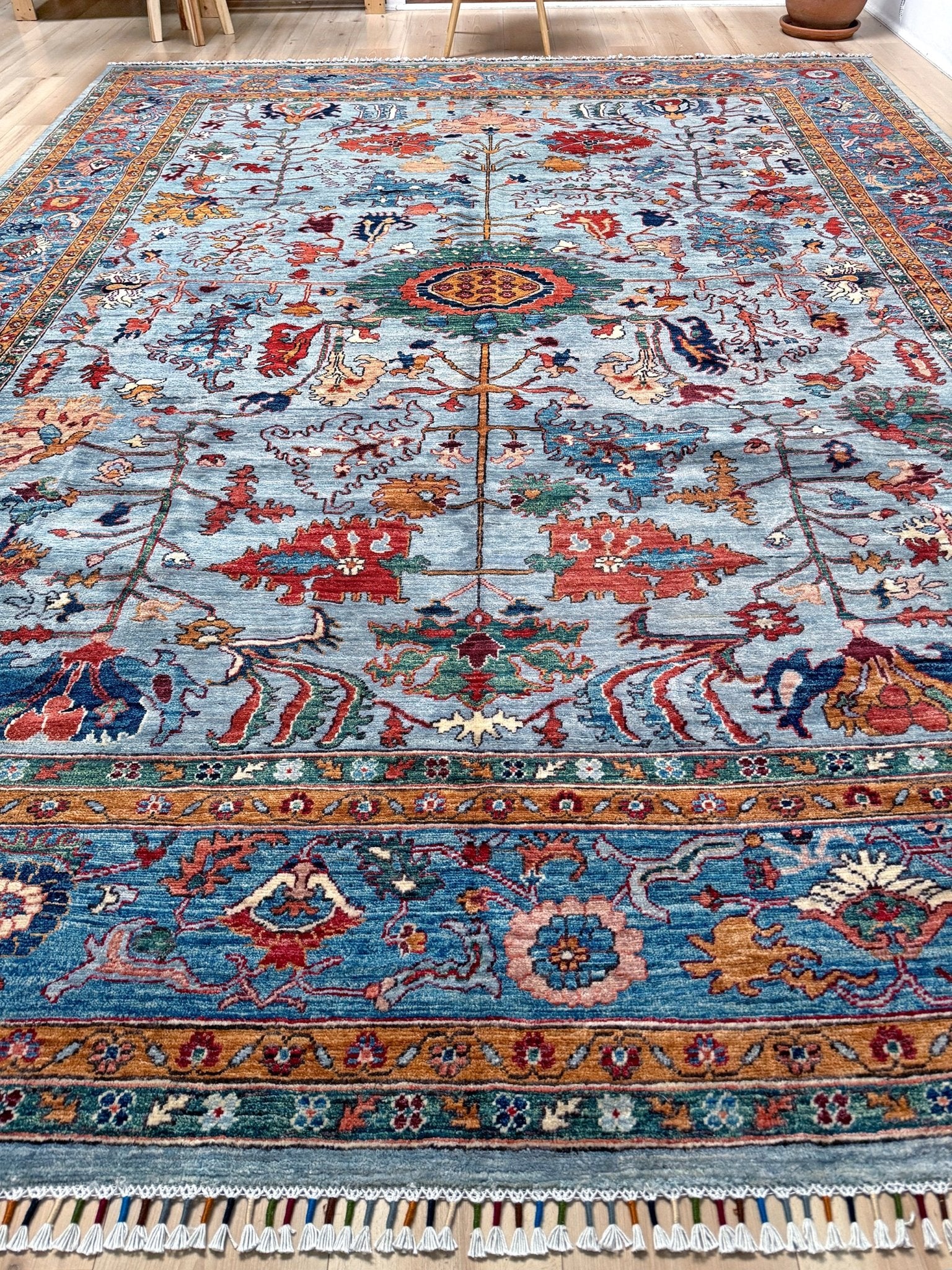 9x12 handmade luxury floral rug with dusty blue background and rich cobalt border, exclusive to the best rug shop in San Mateo, SF Bay Area – perfect for bedroom, living room, or dining room décor, with free shipping included.