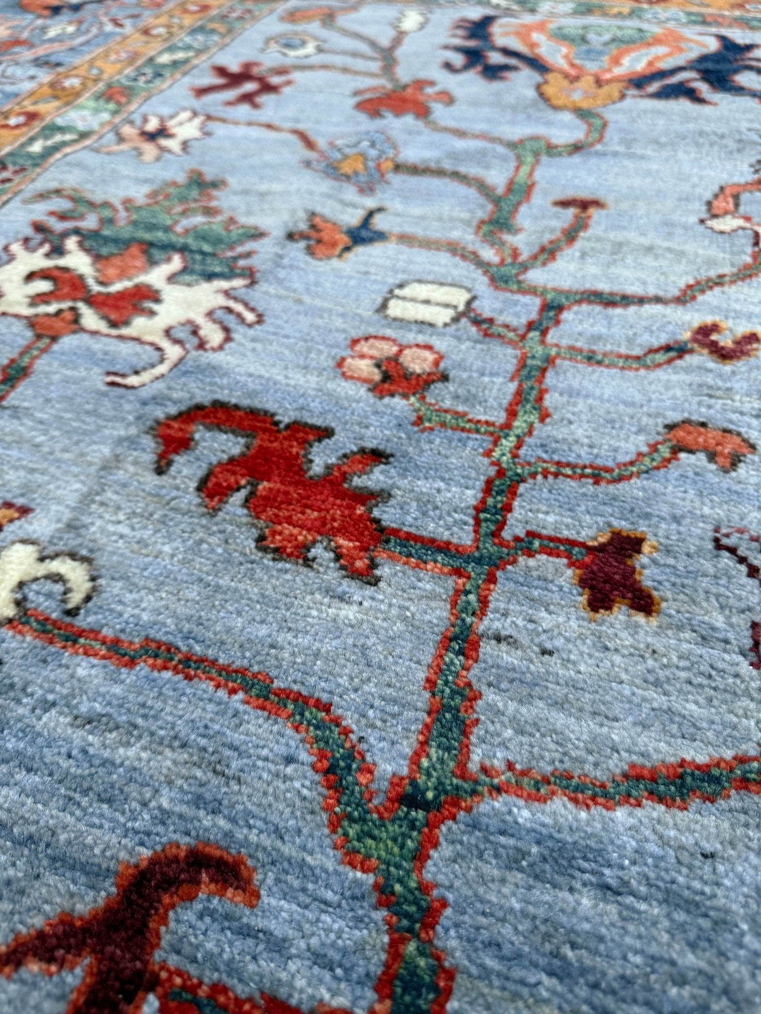 9x12 handmade luxury floral rug with dusty blue background and rich cobalt border, exclusive to the best rug shop in Burlingame CA, SF Bay Area – perfect for bedroom, living room, or dining room décor, with free shipping included.