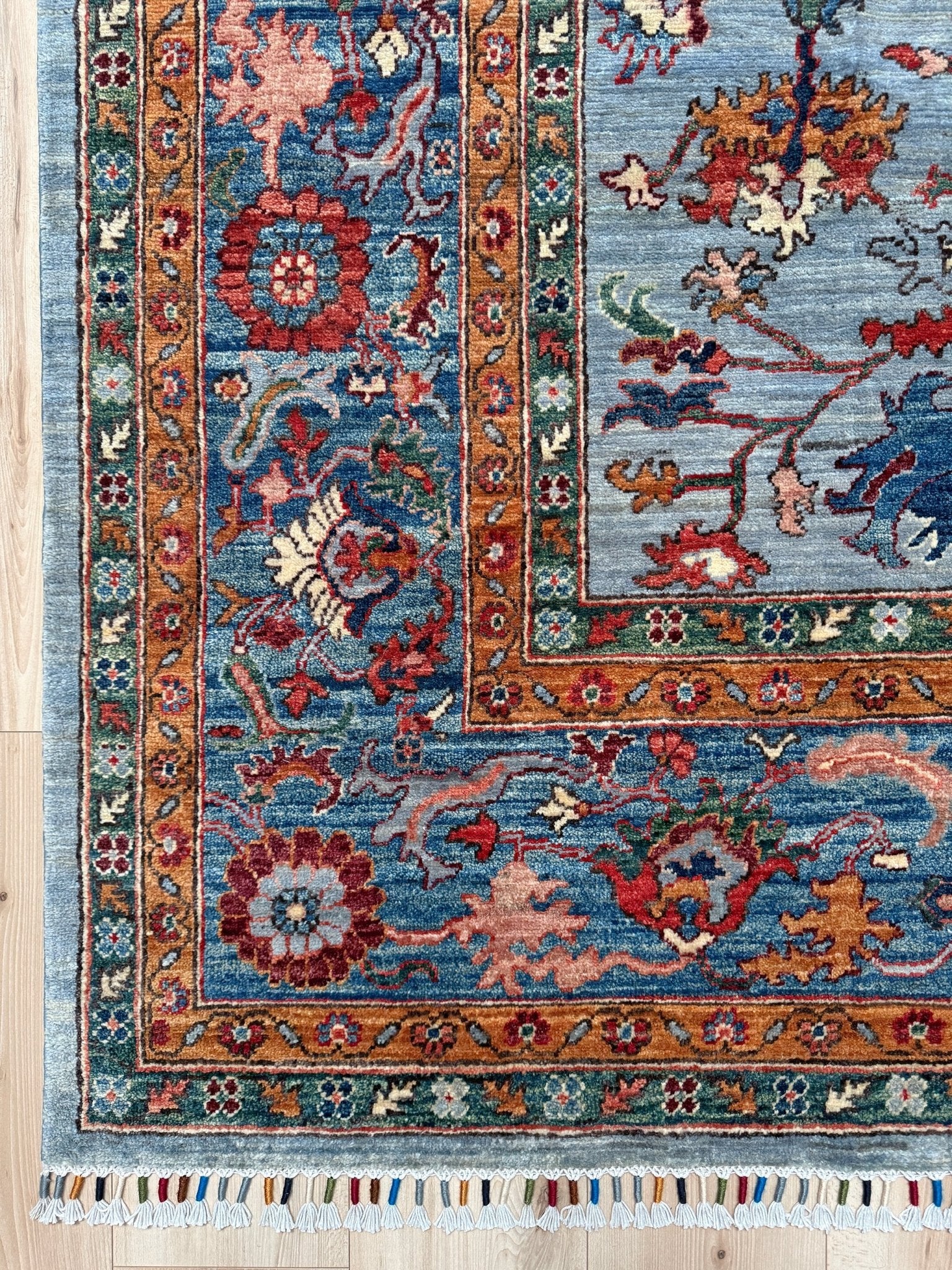 9x12 handmade luxury floral rug with dusty blue background and rich cobalt border, exclusive to the best rug shop in Burlingame CA, SF Bay Area – perfect for bedroom, living room, or dining room décor, with free shipping included.