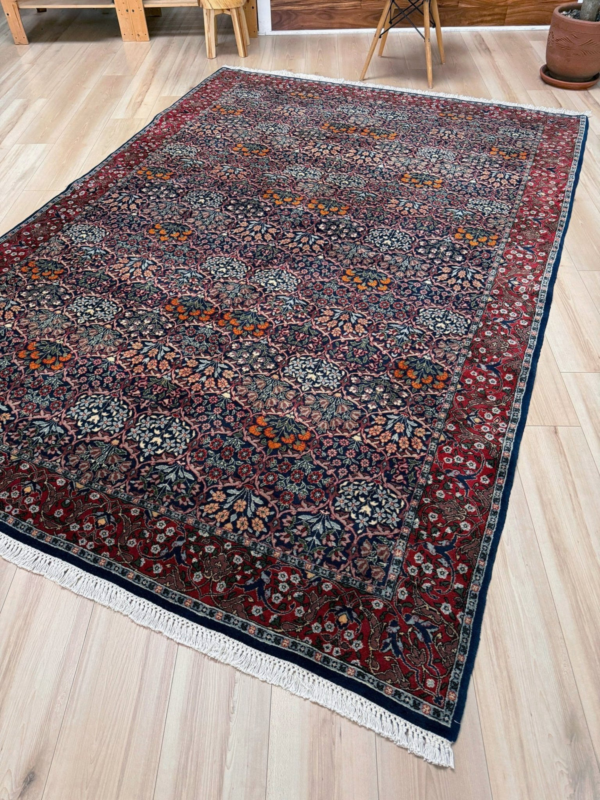 Vintage 7x9 Watermelon Hereke Turkish floral rug with midnight blue field, maroon border. Perfect for living rooms, dining spaces, or bedrooms. From the best rug shop in Burlingame, San Francisco Bay Area, CA