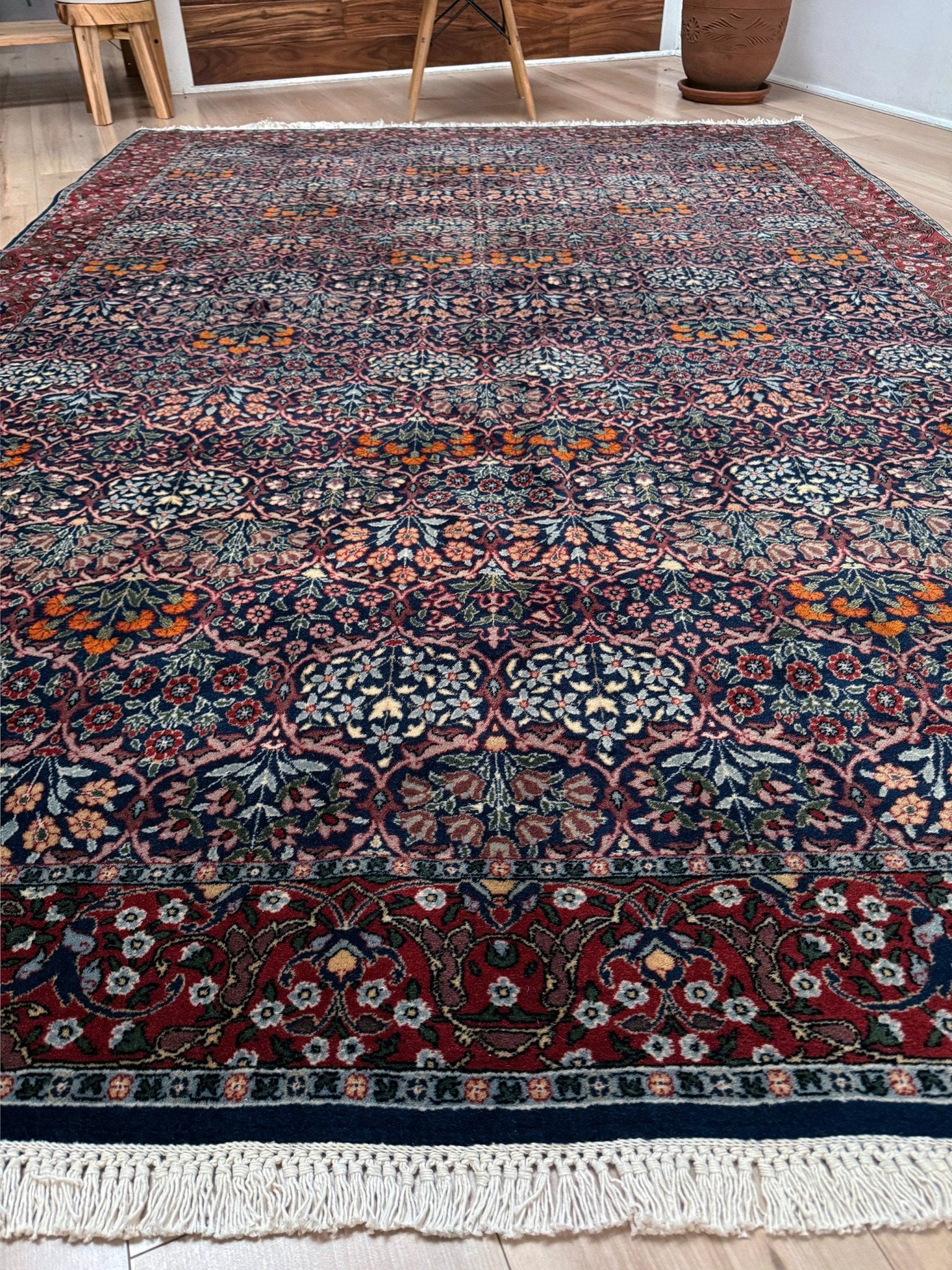 Vintage 1960s 7x9 Watermelon Hereke Turkish floral rug with midnight blue field, maroon border. Perfect for living rooms, dining spaces, or bedrooms. Contemporary yet timeless, from a rug shop in Burlingame, San Francisco Bay Area, CA with free shipping.