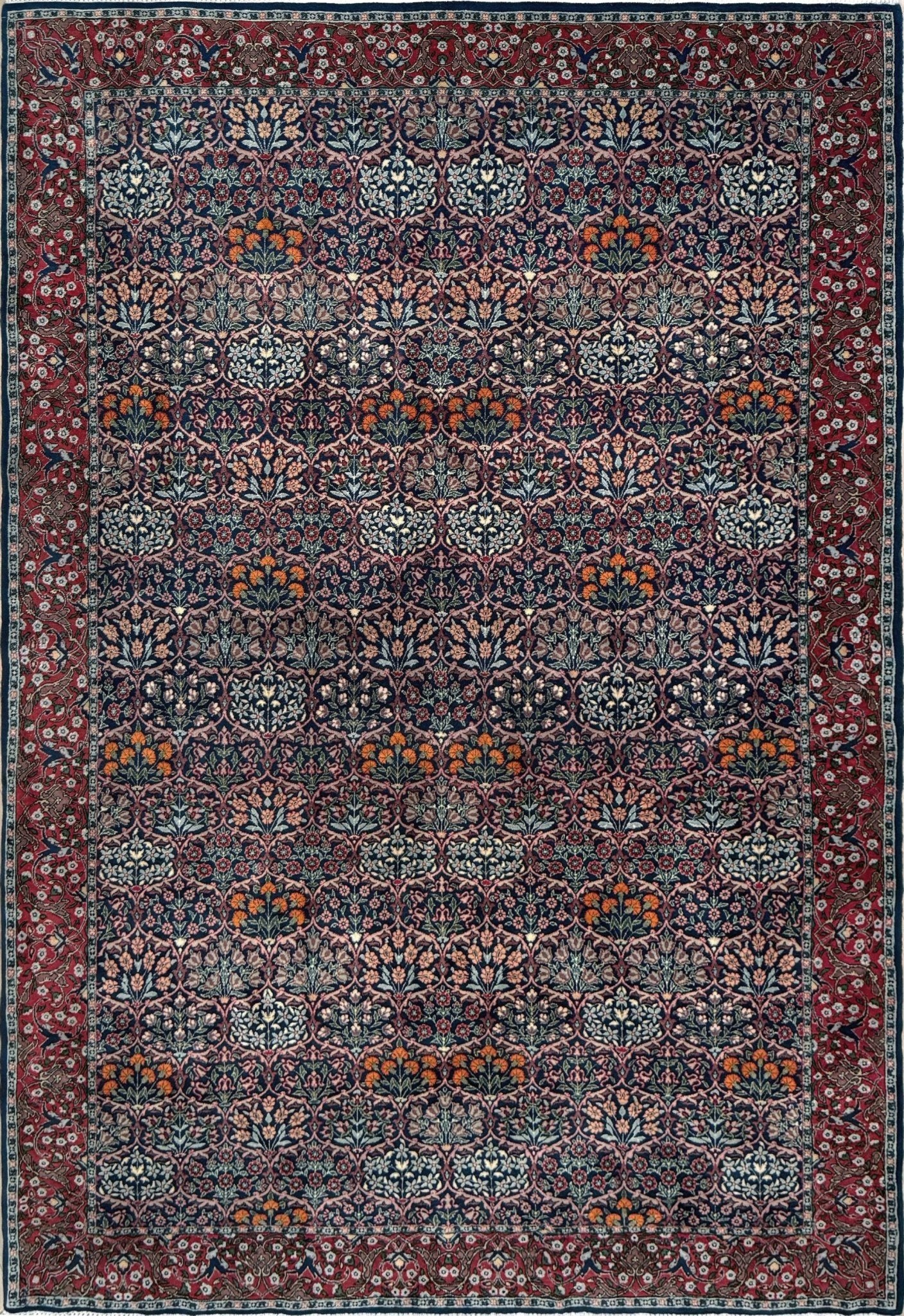 Vintage 1960s 7x9 Watermelon Hereke Turkish floral rug with midnight blue field, maroon border. Perfect for living rooms, dining spaces, or bedrooms. Contemporary yet timeless, from a rug shop in Burlingame, San Francisco Bay Area, CA with free shipping.