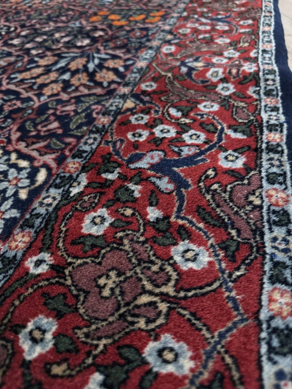 Vintage 7x9 Watermelon Hereke Turkish floral rug with midnight blue field, maroon border. Perfect for living rooms, dining spaces, or bedrooms. From the best rug shop in Burlingame, San Francisco Bay Area, CA