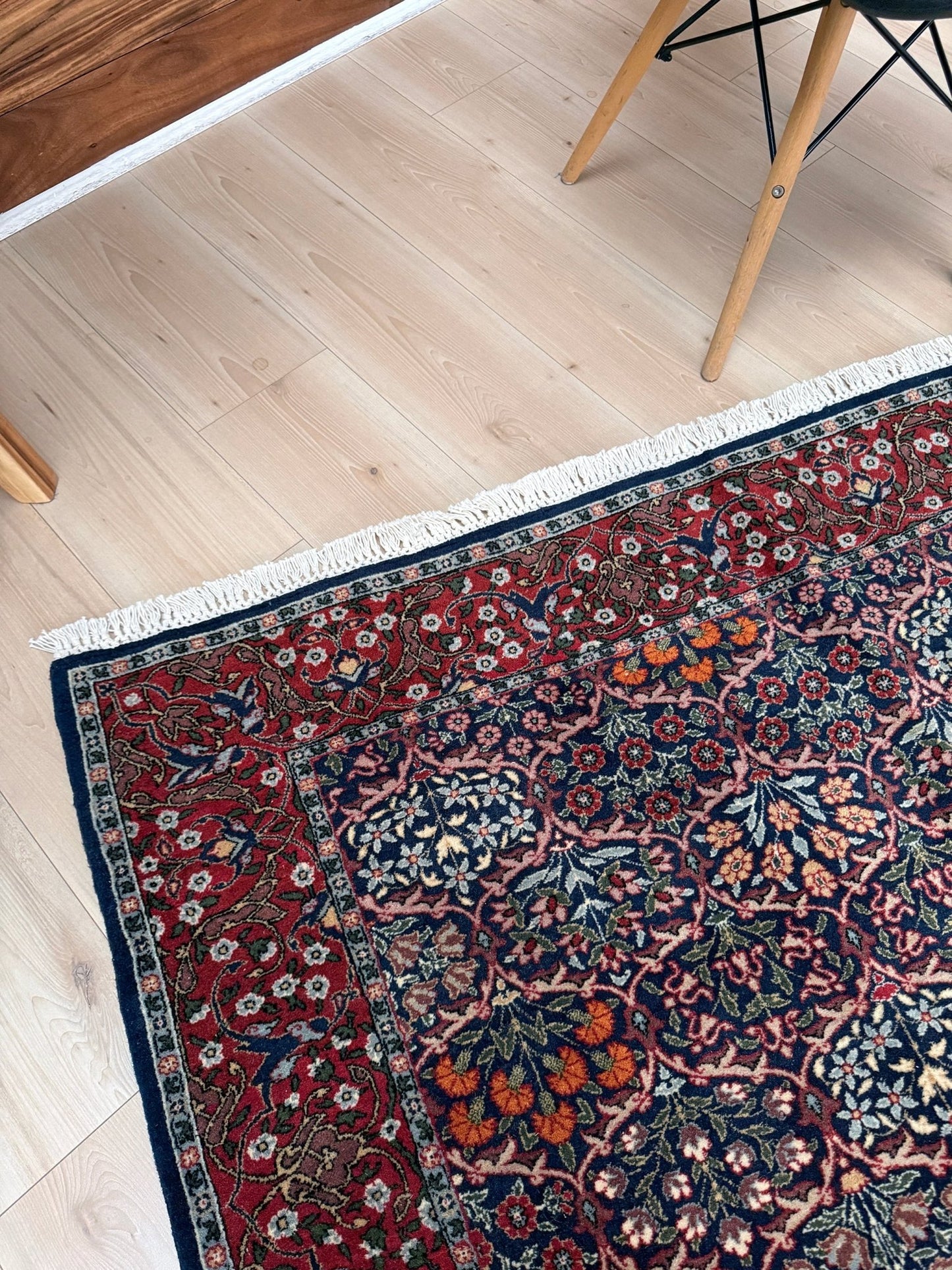 Vintage 1960s 7x9 Watermelon Hereke Turkish floral rug with midnight blue field, maroon border. Perfect for living rooms, dining spaces, or bedrooms. Contemporary yet timeless, from a rug shop in Burlingame, San Francisco Bay Area, CA with free shipping.