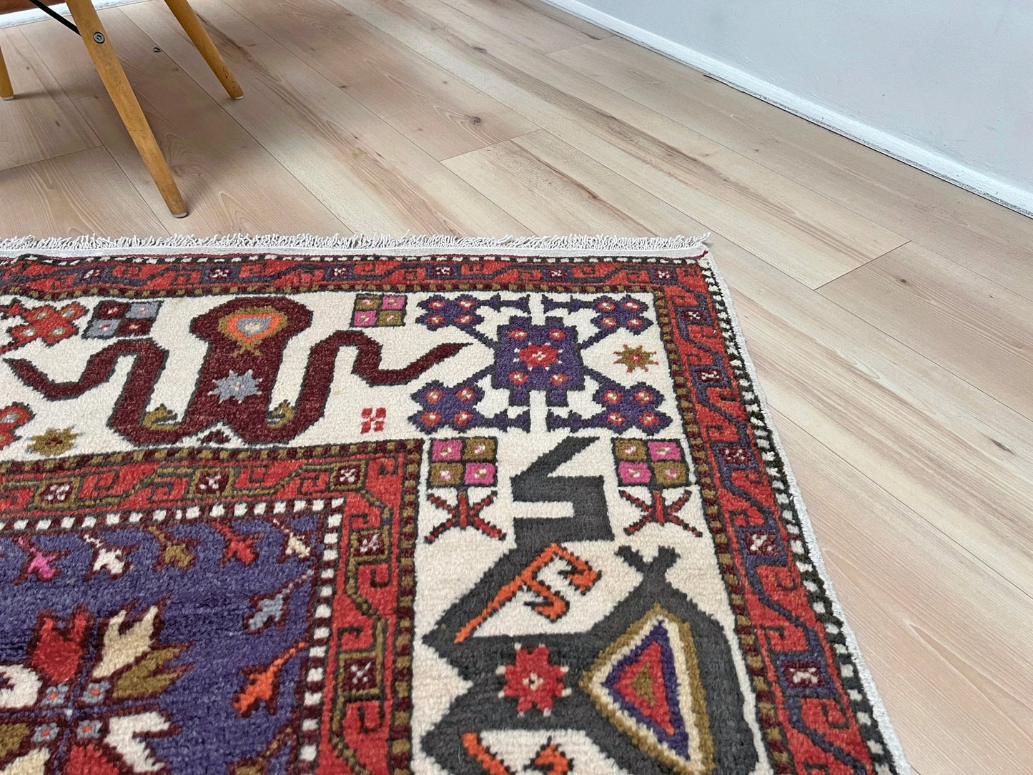 Vintage Turkish Cloudband rug with a golden olive center and bold geometric medallion, surrounded by plum, burgundy, periwinkle, and ivory tribal motifs. Handmade Colorful Vibrant Anatolian wool rug, 6x9 , perfect for living rooms or bedrooms. From Indigo Rugs, Burlingame — San Francisco Bay Area.