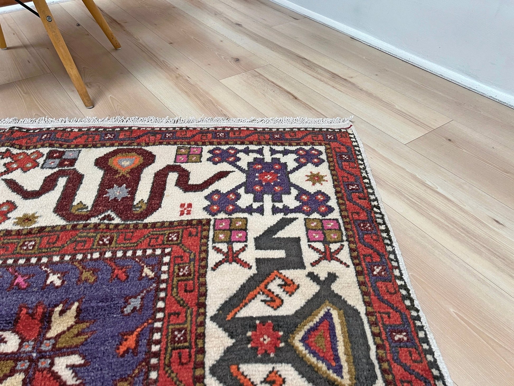 Vintage Turkish Cloudband rug with a golden olive center and bold geometric medallion, surrounded by plum, burgundy, periwinkle, and ivory tribal motifs. Handmade Colorful Vibrant Anatolian wool rug, 6x9 , perfect for living rooms or bedrooms. From Indigo Rugs, Burlingame — San Francisco Bay Area.