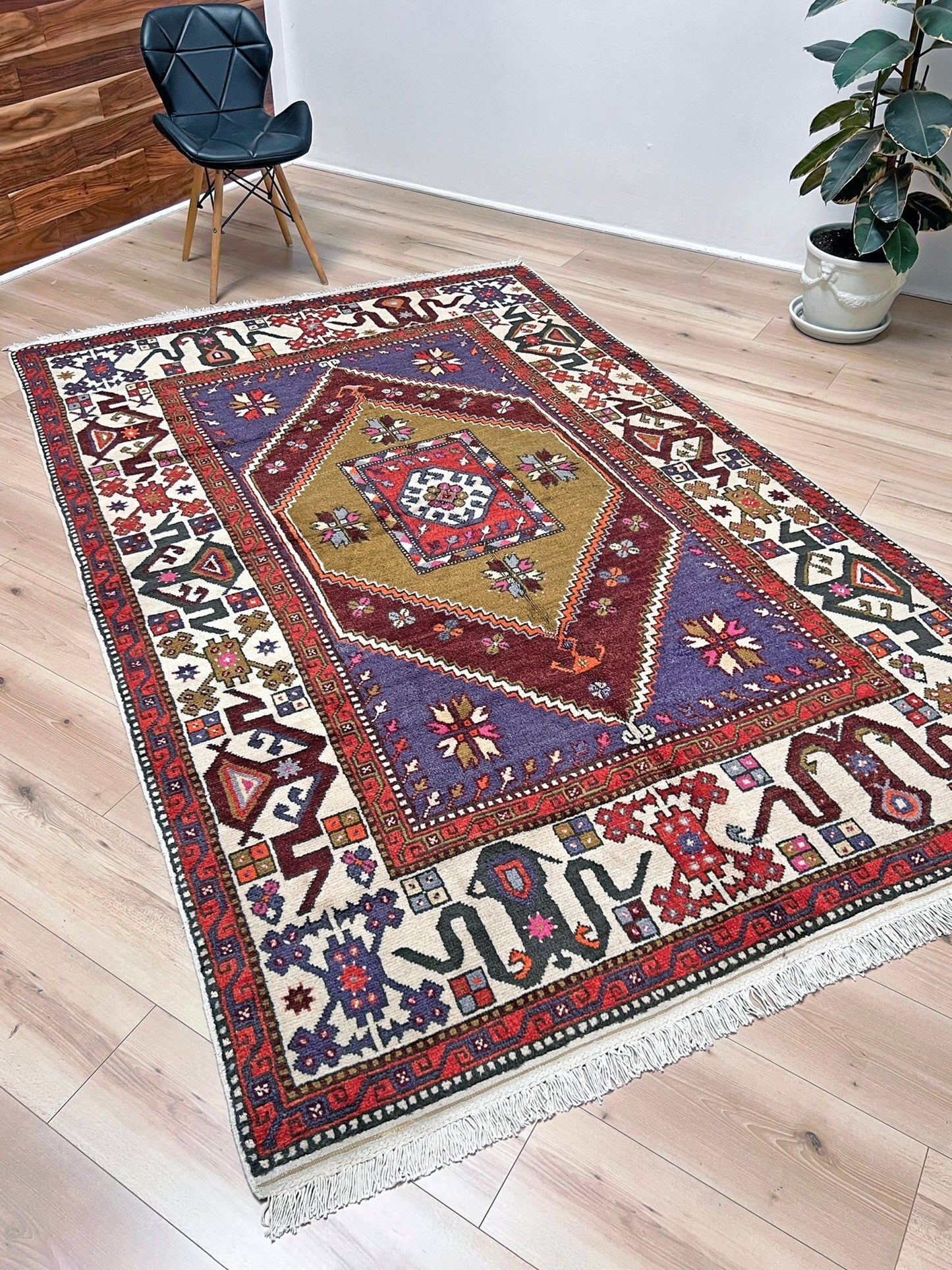 Vintage Turkish Cloudband rug with a golden olive center and bold geometric medallion, surrounded by plum, burgundy, periwinkle, and ivory tribal motifs. Handmade Colorful Vibrant Anatolian wool rug, 6x9 , perfect for living rooms or bedrooms. From Indigo Rugs, Burlingame — San Francisco Bay Area.