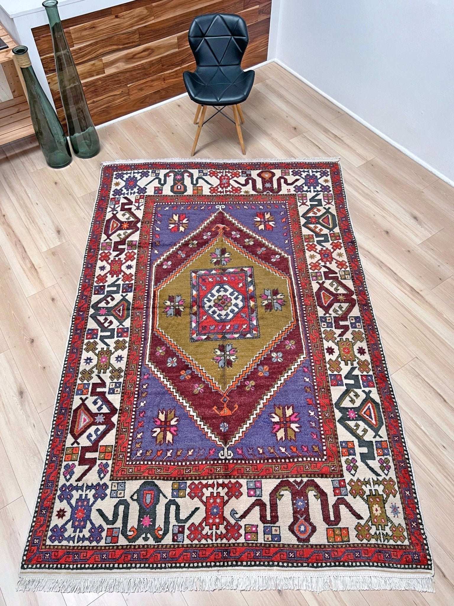 Vintage Turkish Cloudband rug with a golden olive center and bold geometric medallion, surrounded by plum, burgundy, periwinkle, and ivory tribal motifs. Handmade Colorful Vibrant Anatolian wool rug, 6x9 , perfect for living rooms or bedrooms. From Indigo Rugs, Burlingame — San Francisco Bay Area.