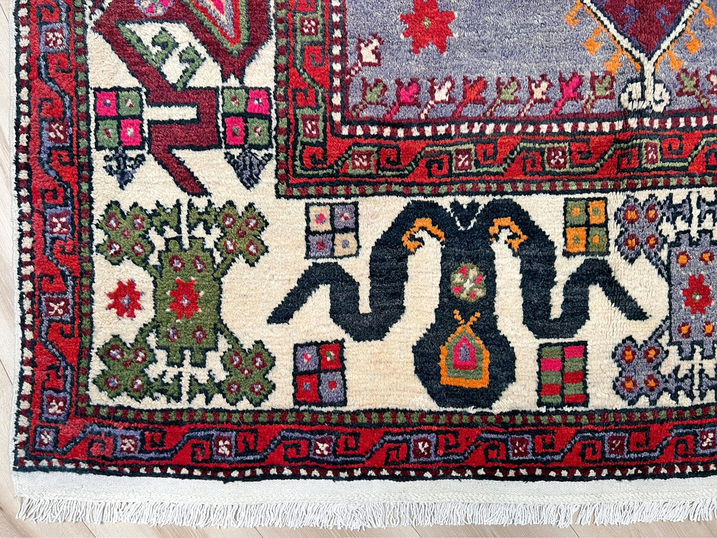 6x9 handmade Turkish vintage rug with geometric medallion, tribal motifs, and lavender, red, and sage green tones — shown in living room at Indigo Rugs, Burlingame — San Francisco Bay Area with free shipping
