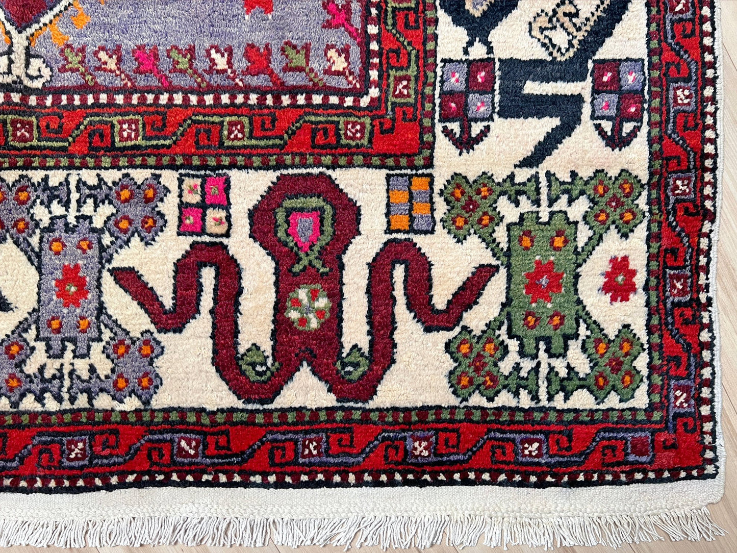 6x9 handmade Turkish vintage rug with geometric medallion, tribal motifs, and lavender, red, and sage green tones — shown in living room at Indigo Rugs, Burlingame — San Francisco Bay Area with free shipping