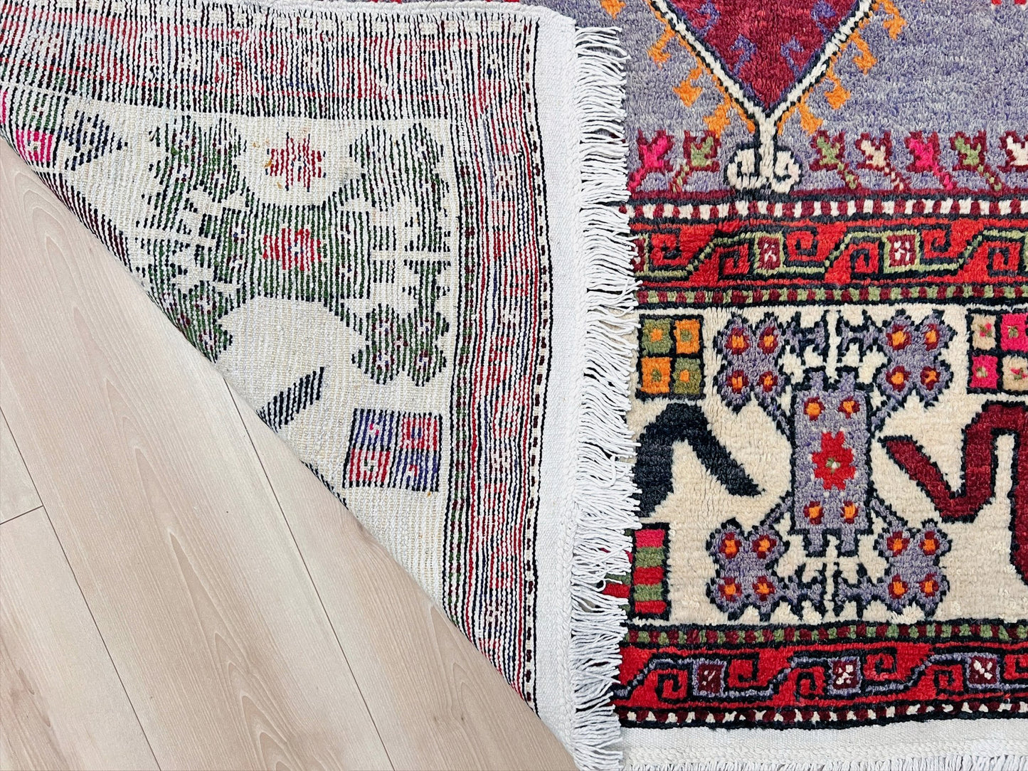 6x9 handmade Turkish vintage rug with geometric medallion, tribal motifs, and lavender, red, and sage green tones — shown in living room at Indigo Rugs, Burlingame — San Francisco Bay Area with free shipping
