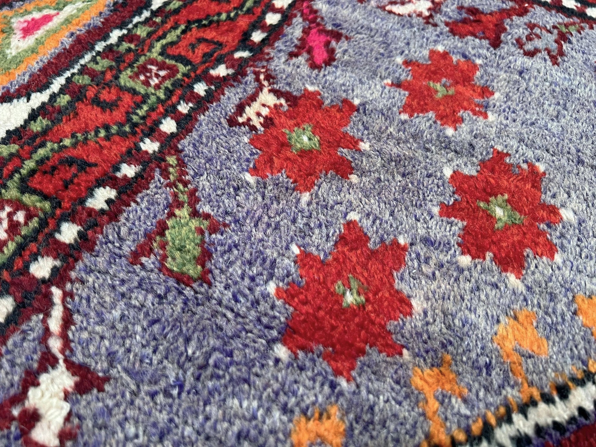 6x9 handmade Turkish vintage rug with geometric medallion, tribal motifs, and lavender, red, and sage green tones — shown in living room at Indigo Rugs, Burlingame — San Francisco Bay Area with free shipping