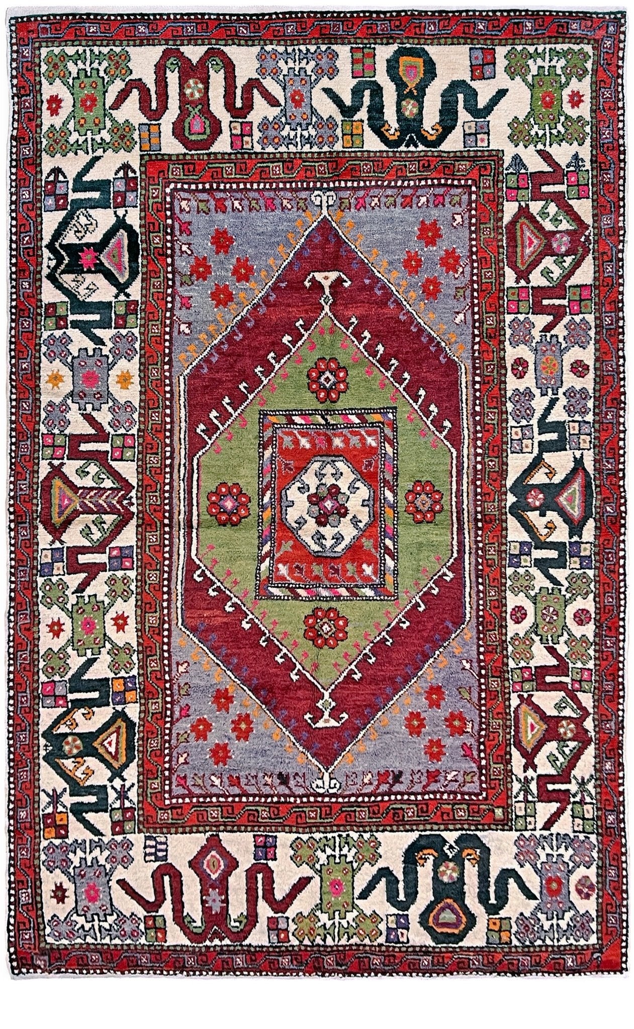 6x9 handmade Turkish vintage rug with geometric medallion, tribal motifs, and lavender, red, and sage green tones — shown in living room at Indigo Rugs, Burlingame — San Francisco Bay Area with free shipping