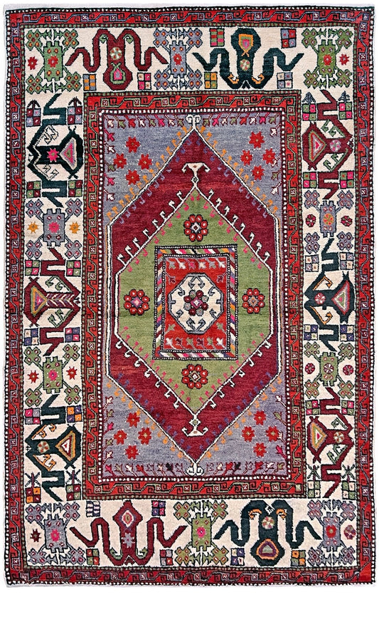 6x9 handmade Turkish vintage rug with geometric medallion, tribal motifs, and lavender, red, and sage green tones — shown in living room at Indigo Rugs, Burlingame — San Francisco Bay Area with free shipping