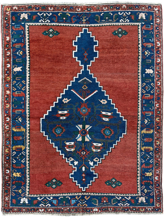 5x7 Vintage Caucasian scatter rug with a terracotta field and a bold midnight blue geometric medallion, accented with melon, ivory, and baby blue motifs. From  the best rug shop san francisco bay area Burlingame CA free shiping