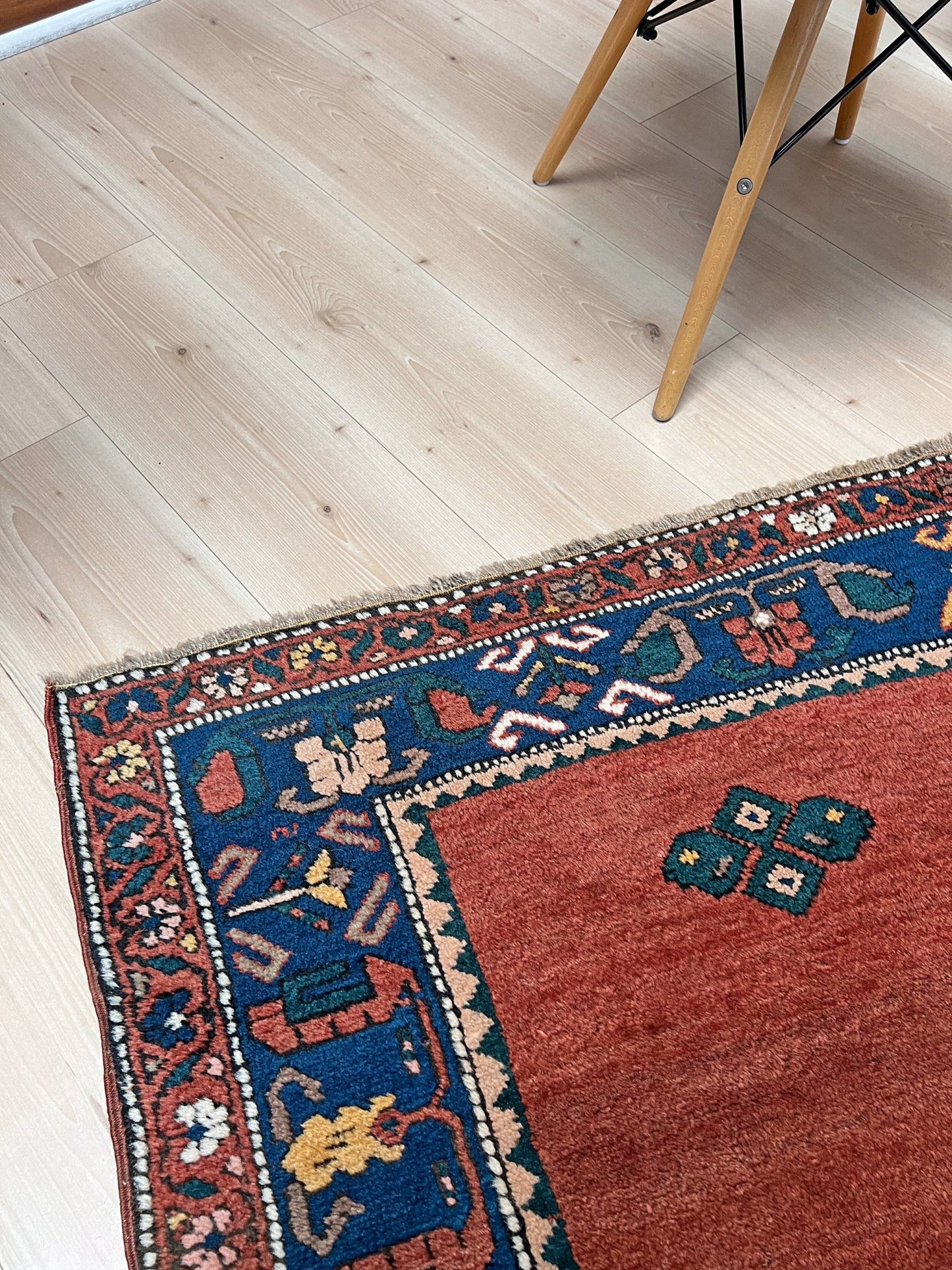 5x7 Vintage Caucasian scatter rug with a terracotta field and a bold midnight blue geometric medallion, accented with melon, ivory, and baby blue motifs. From  the best rug shop san francisco bay area Burlingame CA free shiping