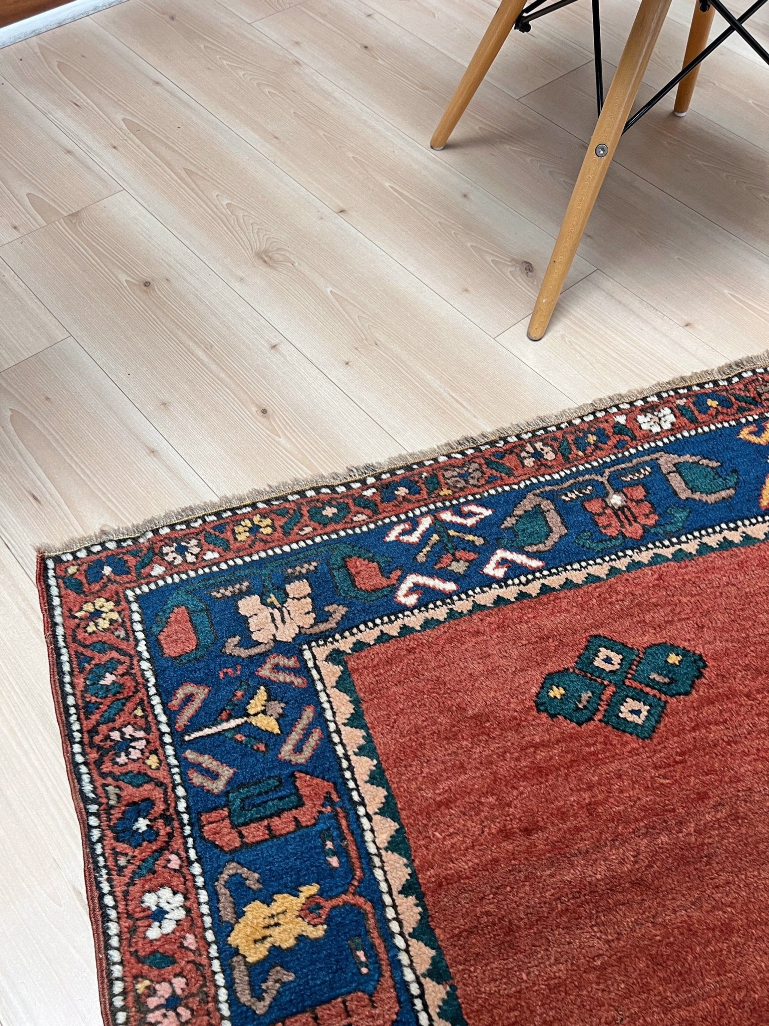 5x7 Vintage Caucasian scatter rug with a terracotta field and a bold midnight blue geometric medallion, accented with melon, ivory, and baby blue motifs. From  the best rug shop san francisco bay area Burlingame CA free shiping