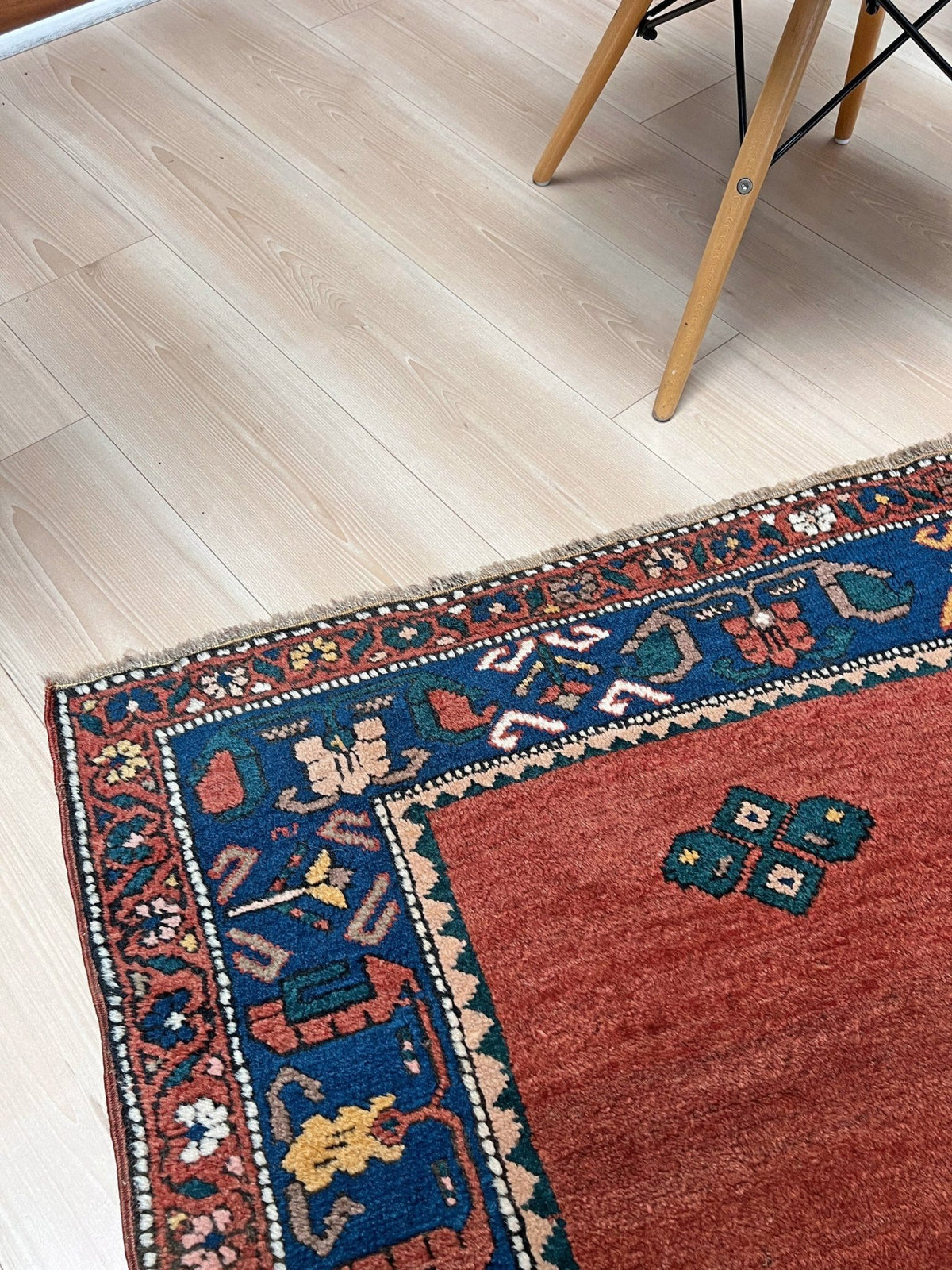 5x7 Vintage Caucasian rug with a terracotta red field and a bold midnight blue geometric medallion. From  the best rug shop san francisco bay area Burlingame CA