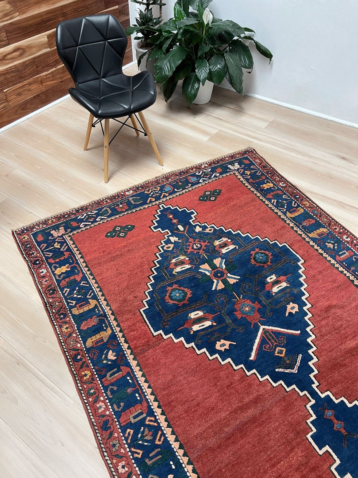 5x7 Vintage Caucasian rug with a terracotta red field and a bold midnight blue geometric medallion. From  the best rug shop san francisco bay area Burlingame CA