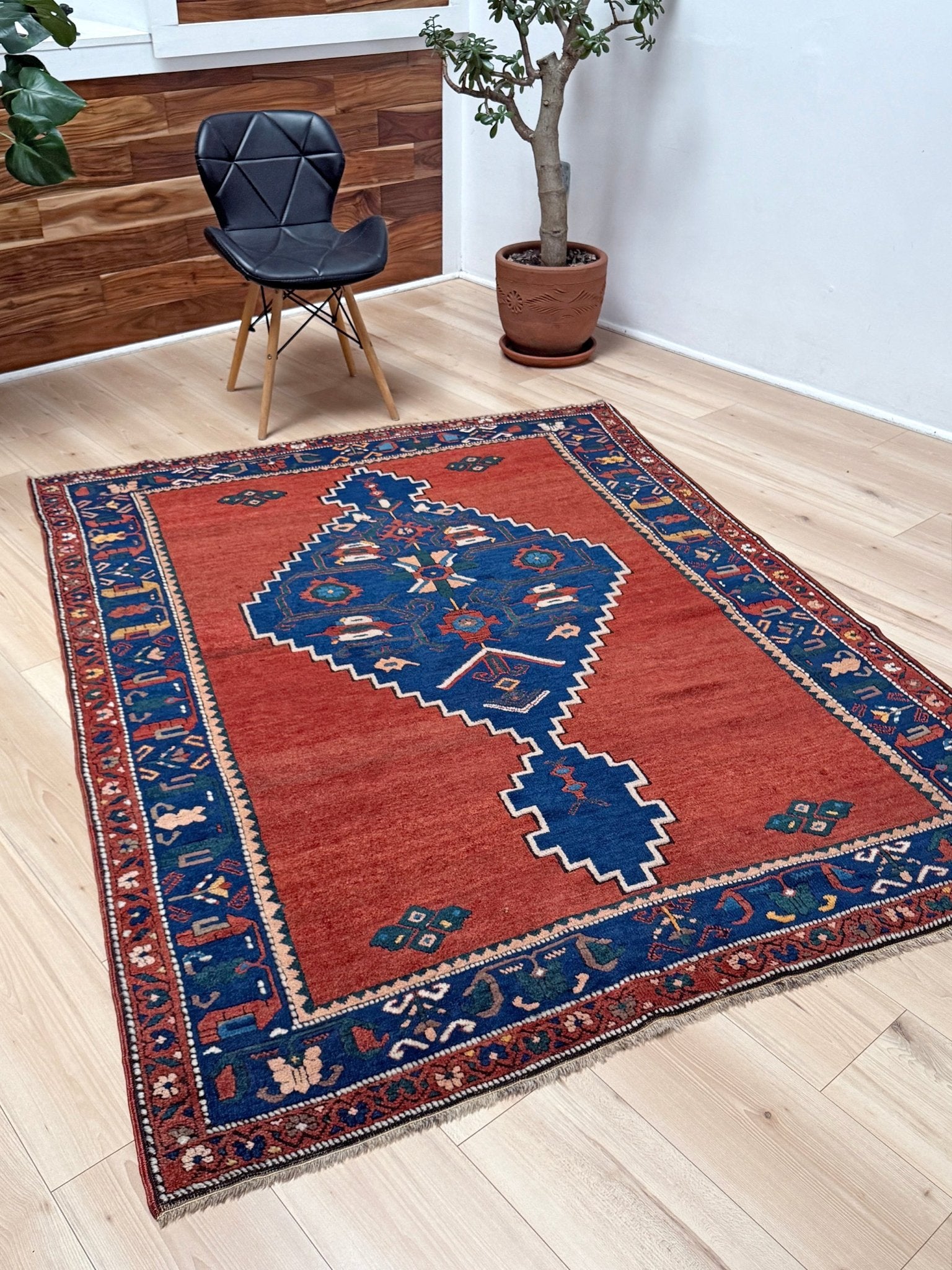 5x7 Vintage Caucasian scatter rug with a terracotta field and a bold midnight blue geometric medallion, accented with melon, ivory, and baby blue motifs. From  the best rug shop san francisco bay area Burlingame CA free shiping