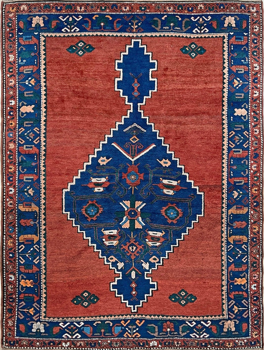 5x7 Vintage Caucasian scatter rug with a terracotta field and a bold midnight blue geometric medallion, accented with melon, ivory, and baby blue motifs. From  the best rug shop san francisco bay area Burlingame CA free shiping