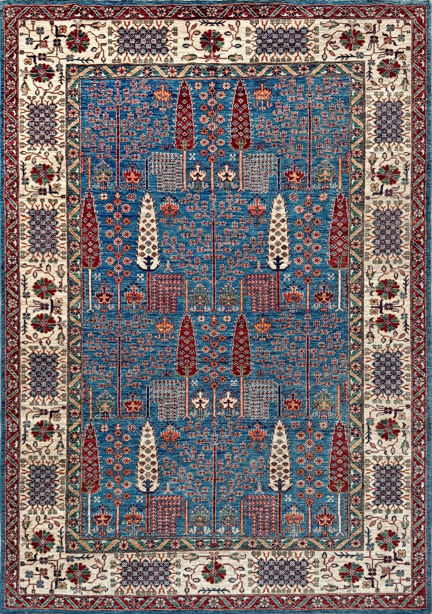 6x9 Luxury Tree of Life rug made of high-quality Ghazni wool, featuring a rich sapphire blue background with intricate floral and cypress tree motifs. Handmade and durable, perfect for the bedroom, living room, or dining area. Available from the best rug shop in San Mateo, SF Bay Area, with free shipping.