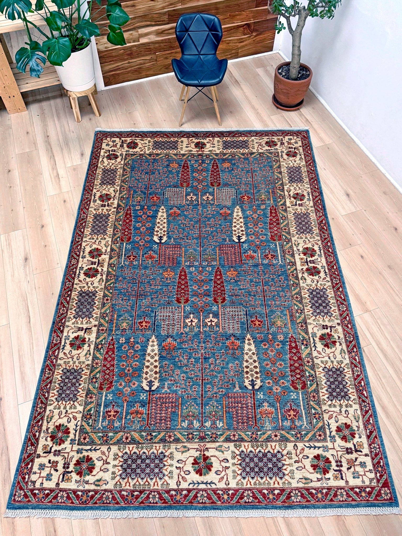 6x9 Luxury Tree of Life rug made of high-quality Ghazni wool, featuring a rich sapphire blue background with intricate floral and cypress tree motifs. Handmade and durable, perfect for the bedroom, living room, or dining area. Available from the best rug shop in San Mateo, SF Bay Area, with free shipping.