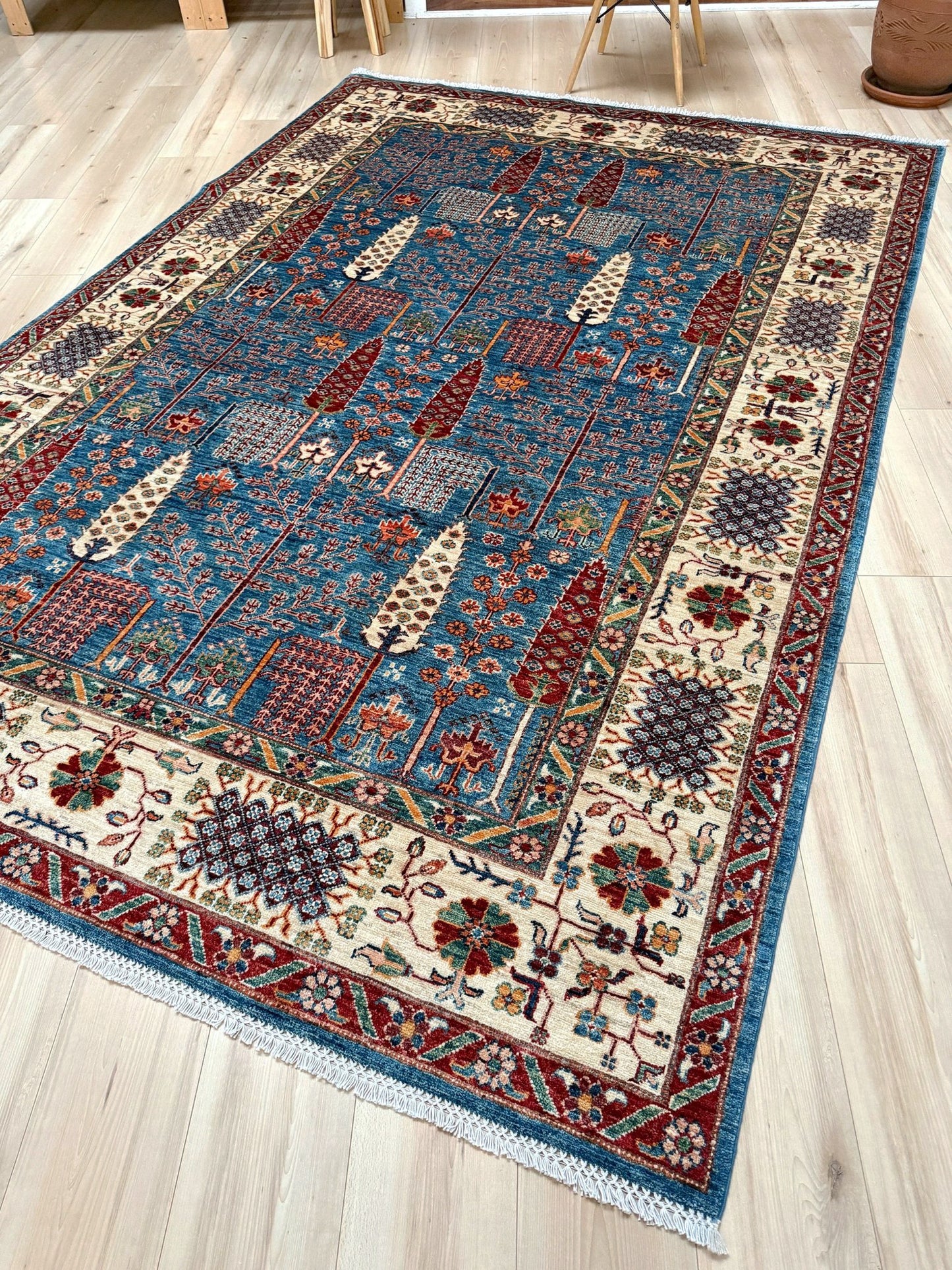 6x9 Luxury Tree of Life rug made of high-quality Ghazni wool, featuring a rich sapphire blue background with intricate floral and cypress tree motifs. Handmade and durable, perfect for the bedroom, living room, or dining area. Available from the best rug shop in San Mateo, SF Bay Area, with free shipping.