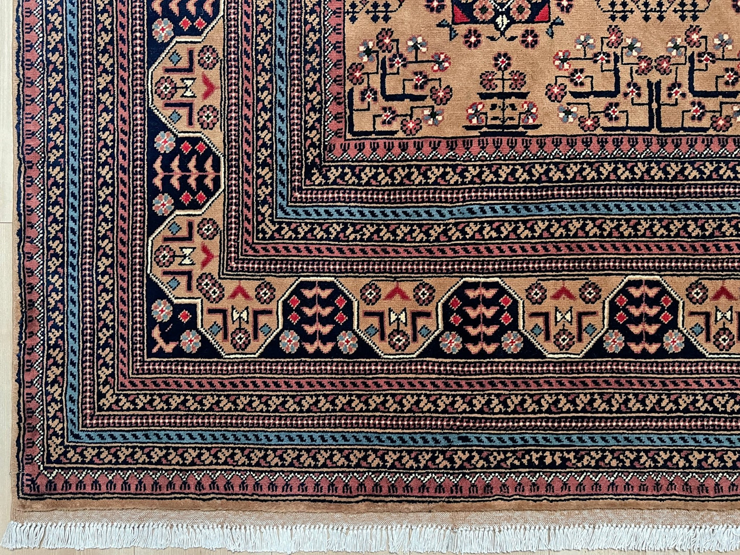 Border detail of  Sand Bilcik Turkmen wool area rug with intricate medallion motifs and ornate indigo and rust borders, perfect for living room, bedroom, or dining room decor. Sold by the best handmade luxury rug shop in the San Francisco Bay Area.