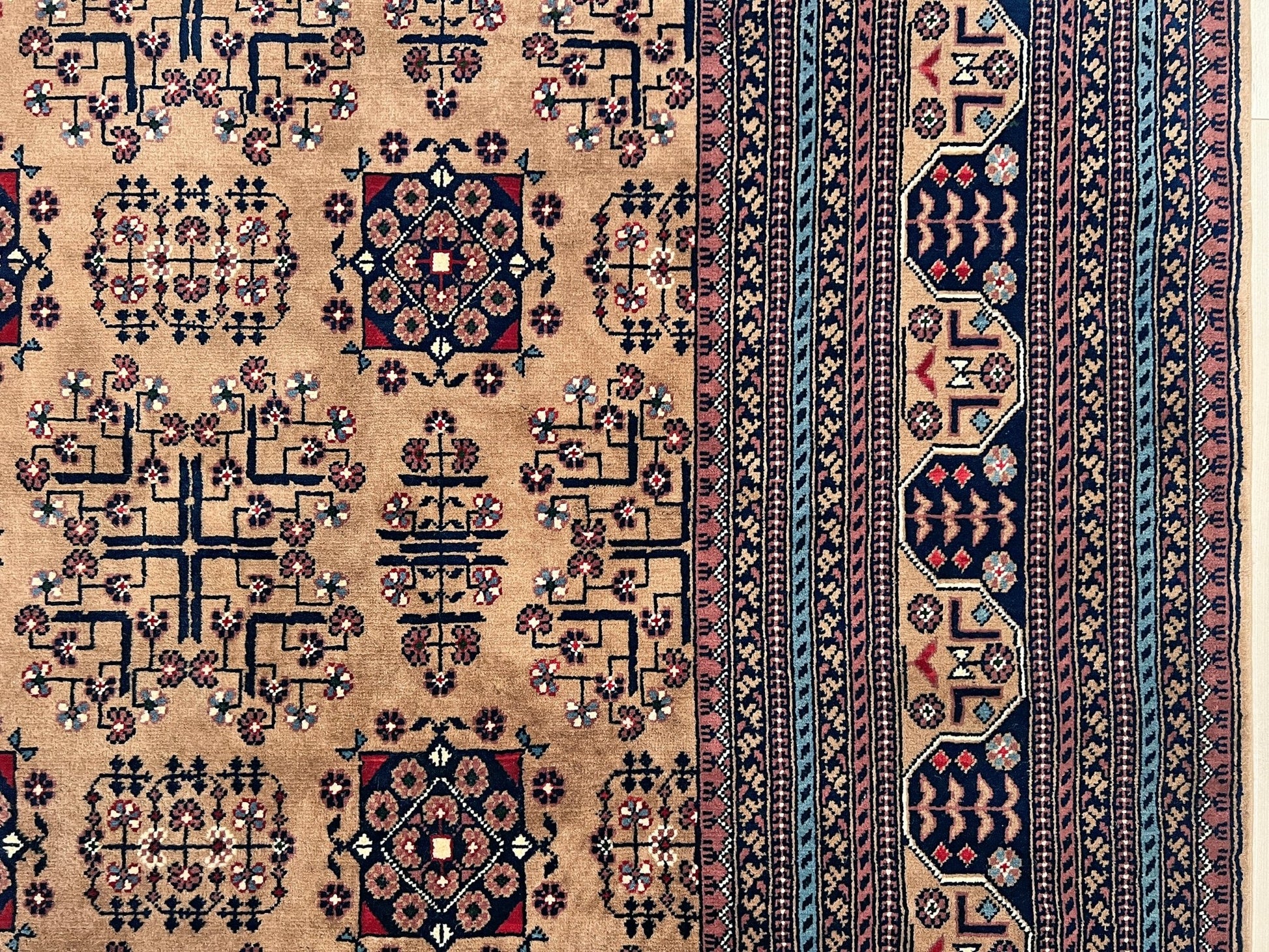 Border detail of Sand Bilcik Turkmen wool area rug with intricate medallion motifs and ornate indigo and rust borders, perfect for living room, bedroom, or dining room decor. Sold by the best handmade luxury rug shop in the San Francisco Bay Area.