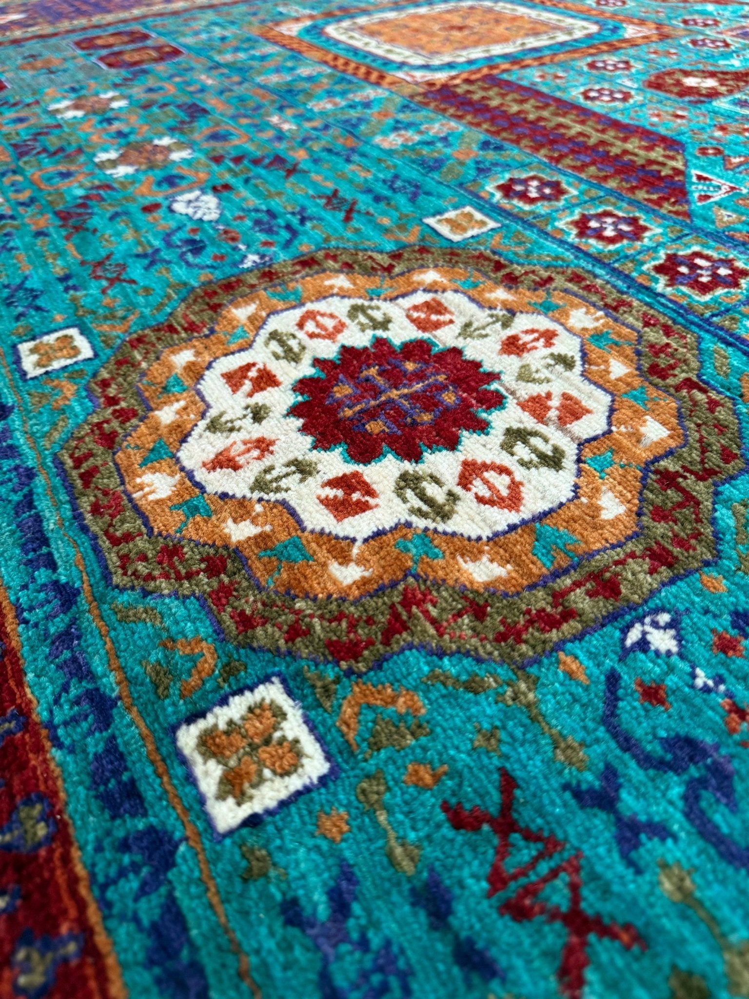 Close-up 45x45 Top-quality 8x10 Sultanate Mamluk rug from the best rug shop in San Mateo, SF Bay Area. It features rich turquoise, royal purple, and saffron hues with intricate geometric patterns. Perfect for a bedroom, living room, or dining space, adding character and timeless elegance. Free shipping available.