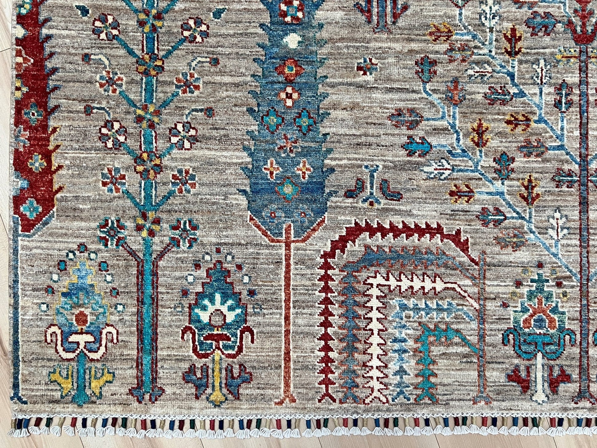 Corner of Tree of Life rug from the best luxury handmade rug shop in the San Francisco Bay Area. This exquisite piece features intricate patterns and vibrant colors, perfect for adding elegance to any space. Enjoy free shipping with your purchase.