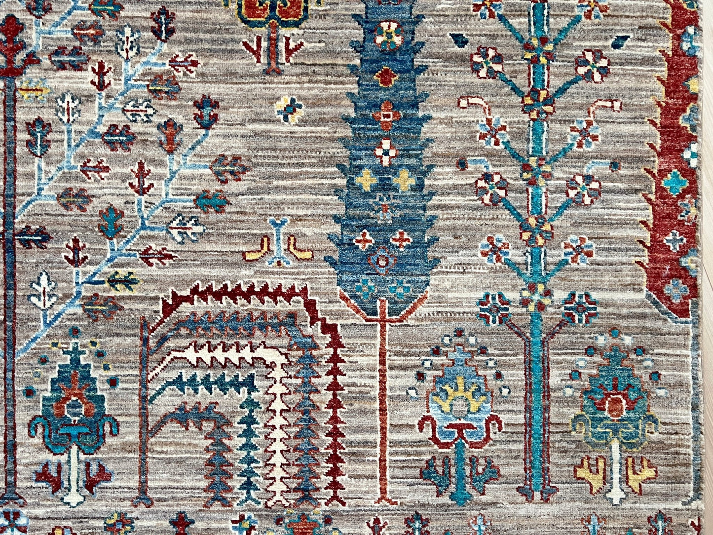 Detail of Tree of Life rug from the best luxury handmade rug shop in the San Francisco Bay Area. This exquisite piece features intricate patterns and vibrant colors, perfect for adding elegance to any space. Enjoy free shipping with your purchase.