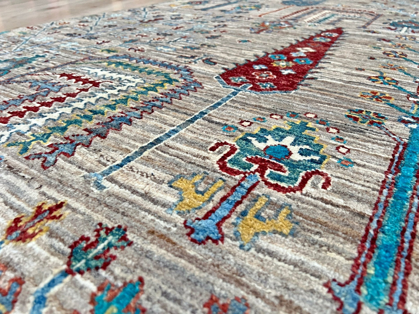 Close up detail of Tree of Life rug from the best luxury handmade rug shop in the San Francisco Bay Area. This exquisite piece features intricate patterns and vibrant colors, perfect for adding elegance to any space. Enjoy free shipping with your purchase.