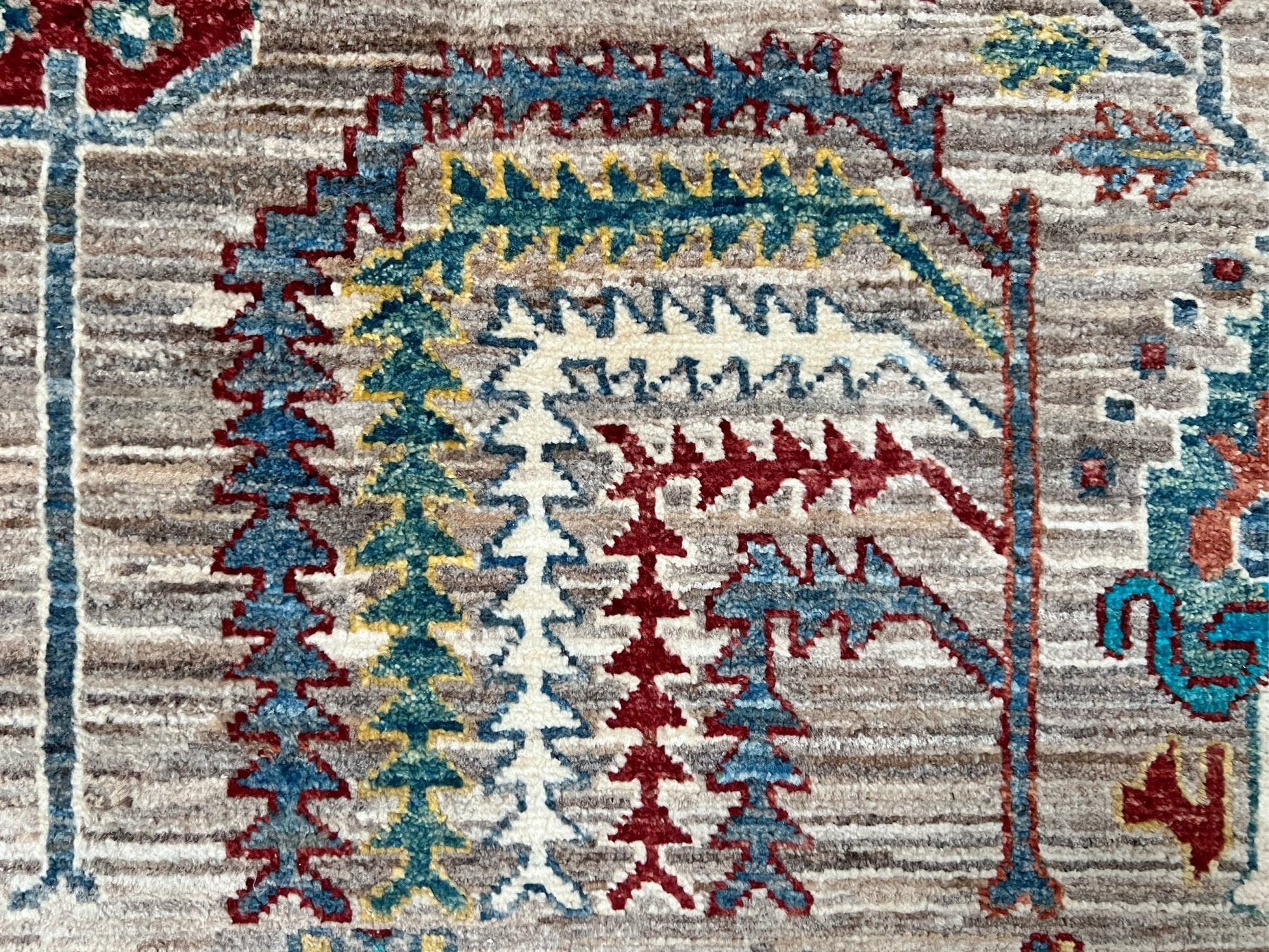 Close up detail of Tree of Life rug from the best luxury handmade rug shop in the San Francisco Bay Area. This exquisite piece features intricate patterns and vibrant colors, perfect for adding elegance to any space. Enjoy free shipping with your purchase.