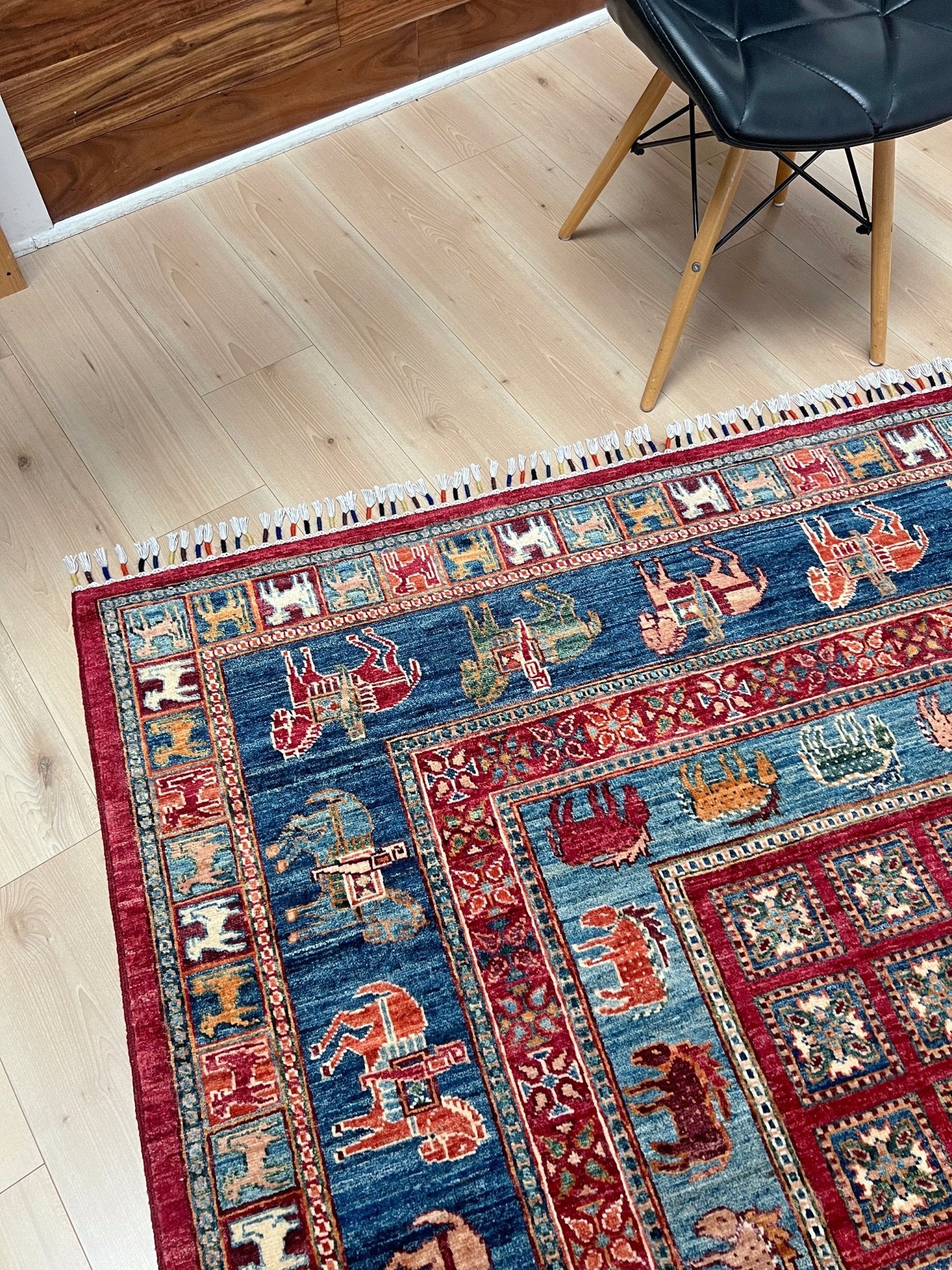 Corner detail of Luxury 6x9 handmade wool rug from Turkey, inspired by ancient Pazyryk motifs, featuring intricate grid patterns and stylized animals, perfect for living rooms, bedrooms, offices, and nurseries. Available at the Beds Rug Shop in the San Francisco Bay Area with free shipping.