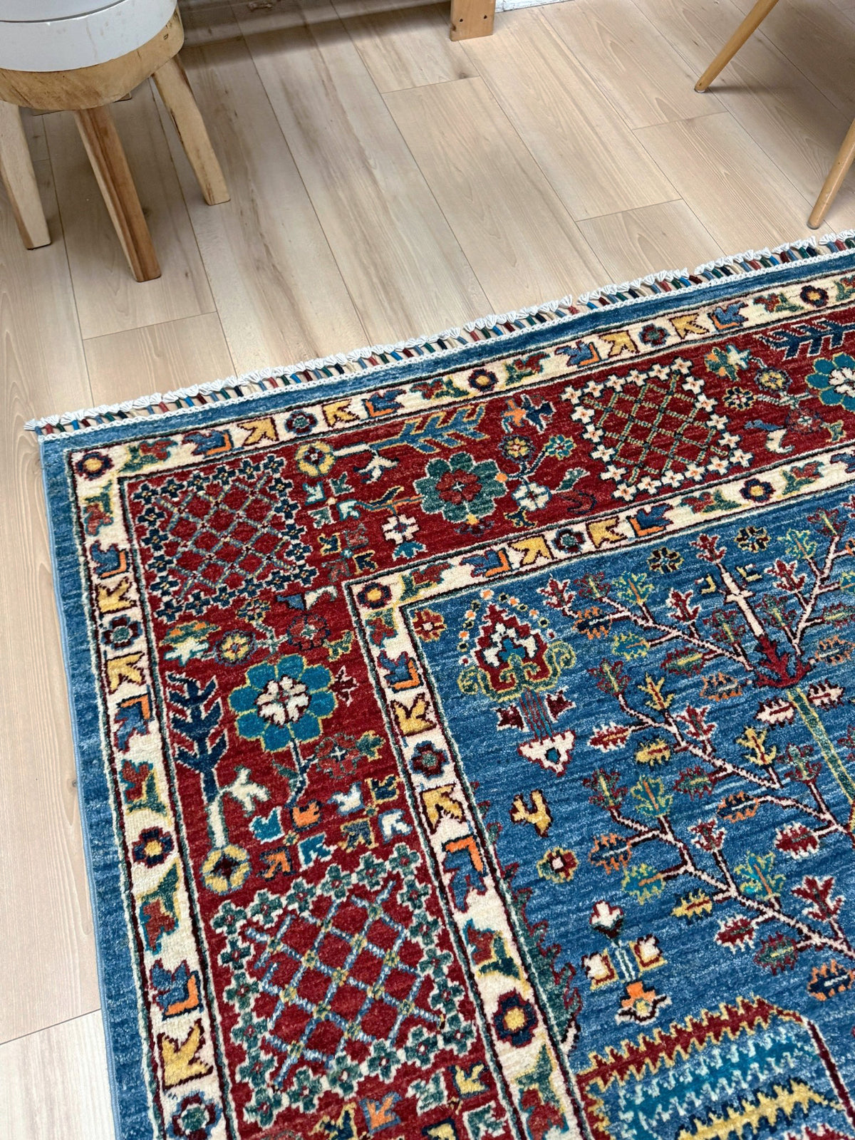 9x12 Tree of Life rug with sky blue field, deep crimson border, cypress trees, floral motifs, handmade wool from Indigo Rugs Burlingame Bay Area.