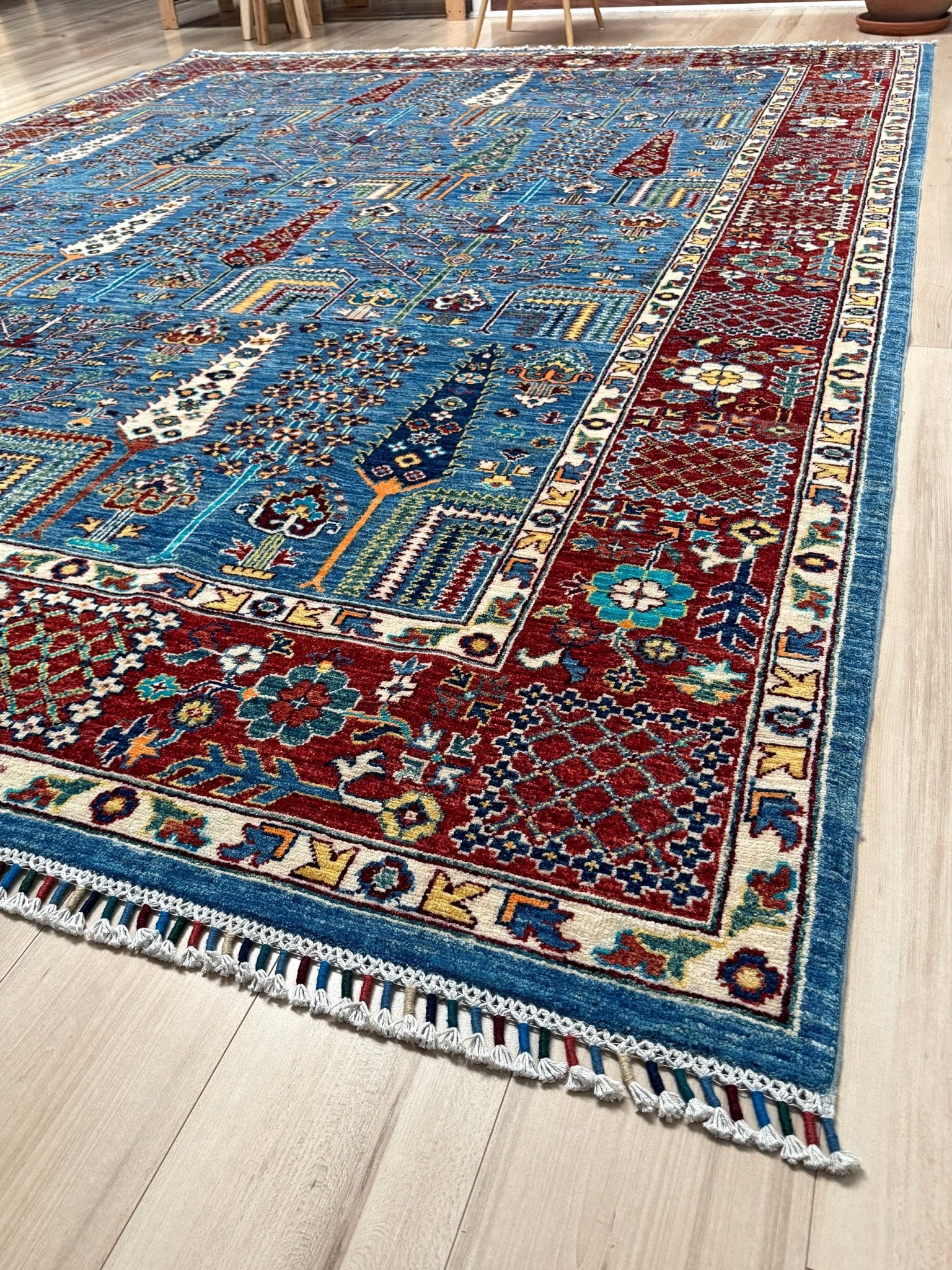 Brand new 9x12 Tree of Life Turkish rug – sky blue with deep crimson red, ivory, and gold accents. Perfect for bedroom, living room, or dining area. High-quality, handmade wool rug from the best rug shop in San Mateo, SF Bay Area. Free shipping available.
