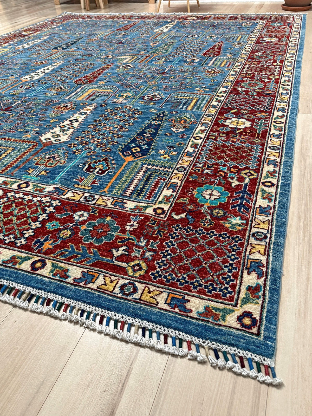 9x12 Tree of Life rug with sky blue field, deep crimson border, cypress trees, floral motifs, handmade wool from Indigo Rugs Burlingame Bay Area.