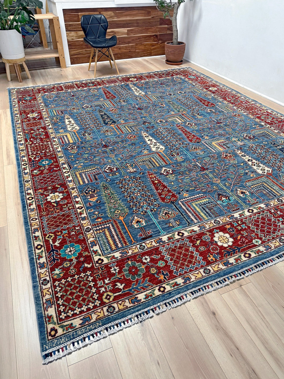 9x12 Tree of Life rug with sky blue field, deep crimson border, cypress trees, floral motifs, handmade wool from Indigo Rugs Burlingame Bay Area.