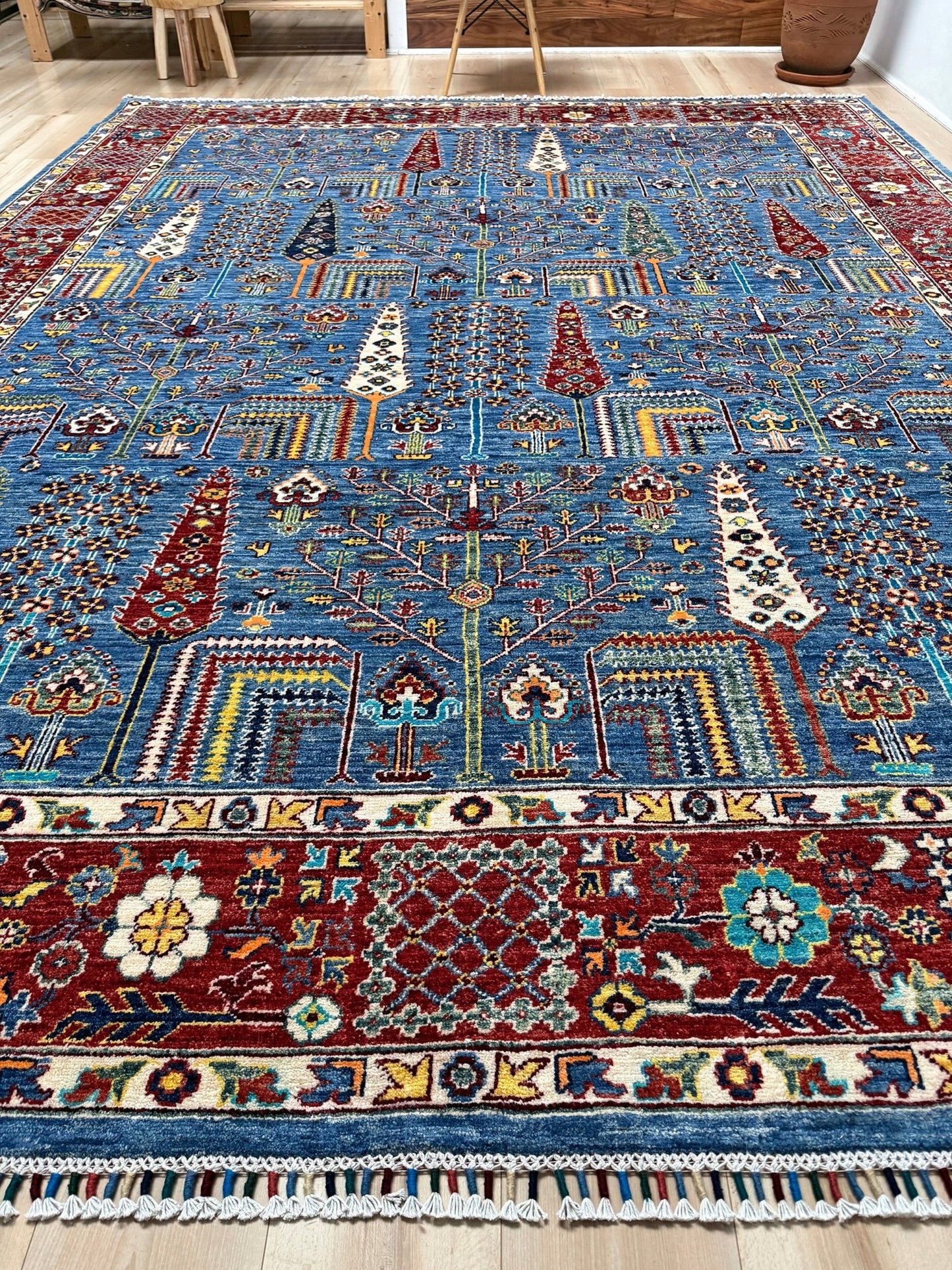 Brand new 9x12 Tree of Life Turkish rug – sky blue with deep crimson red, ivory, and gold accents. Perfect for bedroom, living room, or dining area. High-quality, handmade wool rug from the best rug shop in San Mateo, SF Bay Area. Free shipping available.