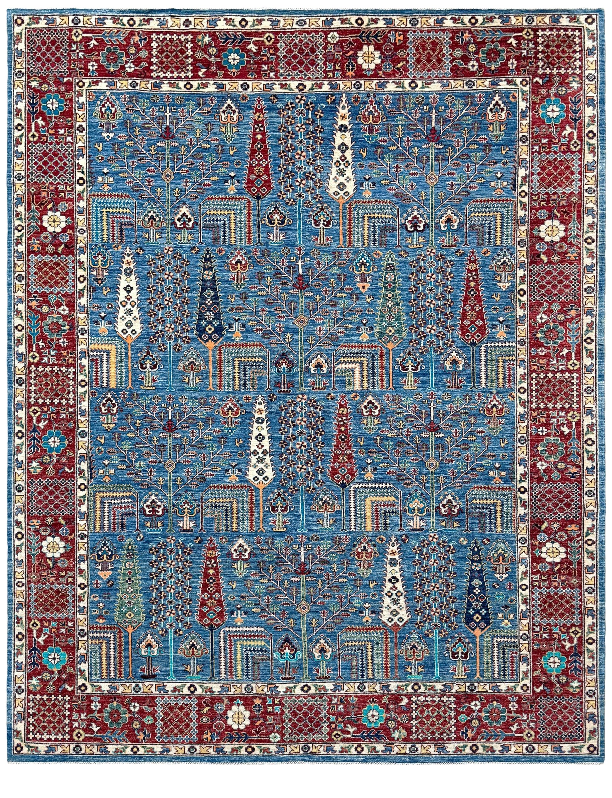 A traditional Persian-style area rug with a complex geometric and floral pattern, featuring a dominant blue center field, a deep red border, and cream accents. Blue Tree of Life 9x12 rug with sky blue field, deep crimson border, cypress trees, floral motifs, handmade wool from Indigo Rugs Burlingame Bay Area.
