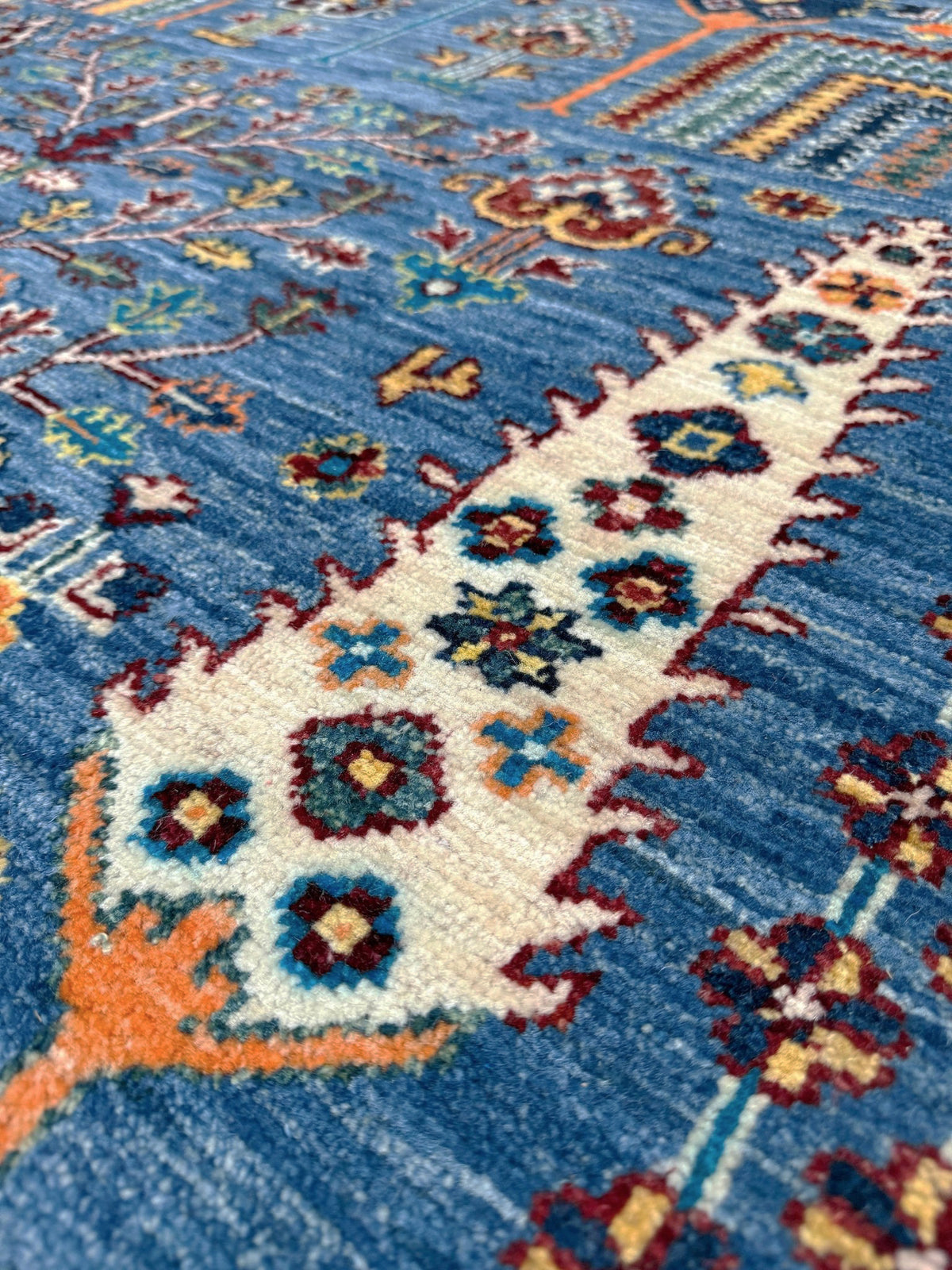 Blue Tree of Life 9x12 rug with sky blue field, deep crimson border, cypress trees, floral motifs, handmade wool from Indigo Rugs Burlingame Bay Area.