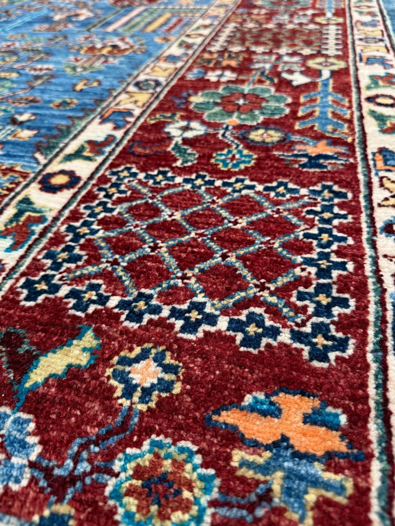 Brand new 9x12 Tree of Life Turkish rug – sky blue with deep crimson red, ivory, and gold accents. Perfect for bedroom, living room, or dining area. High-quality, handmade wool rug from the best rug shop in Burlingame CA, SF Bay Area. Free shipping available.