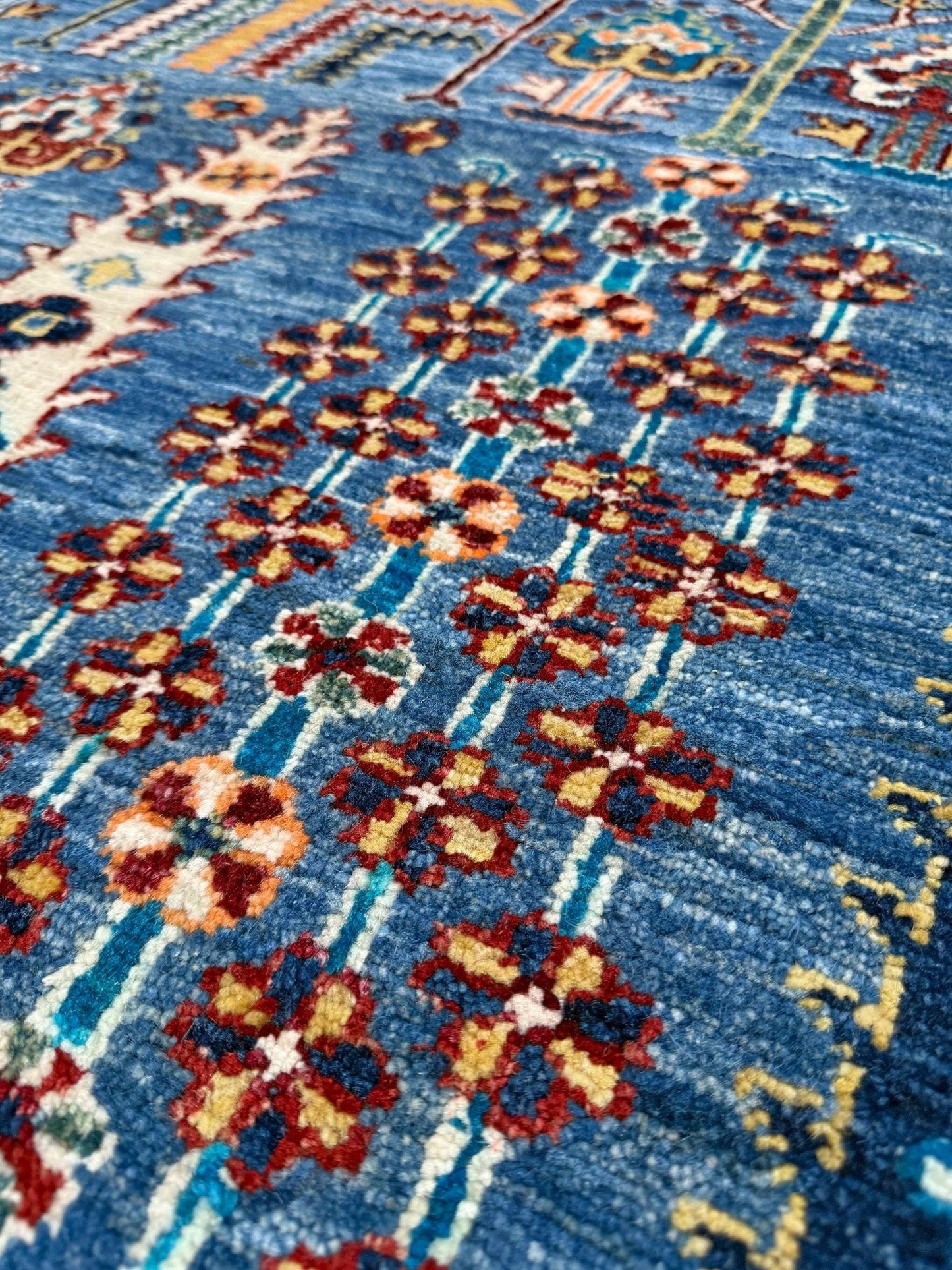 Brand new 9x12 Tree of Life Turkish rug – sky blue with deep crimson red, ivory, and gold accents. Perfect for bedroom, living room, or dining area. High-quality, handmade wool rug from the best rug shop in Burlingame CA, SF Bay Area. Free shipping available.