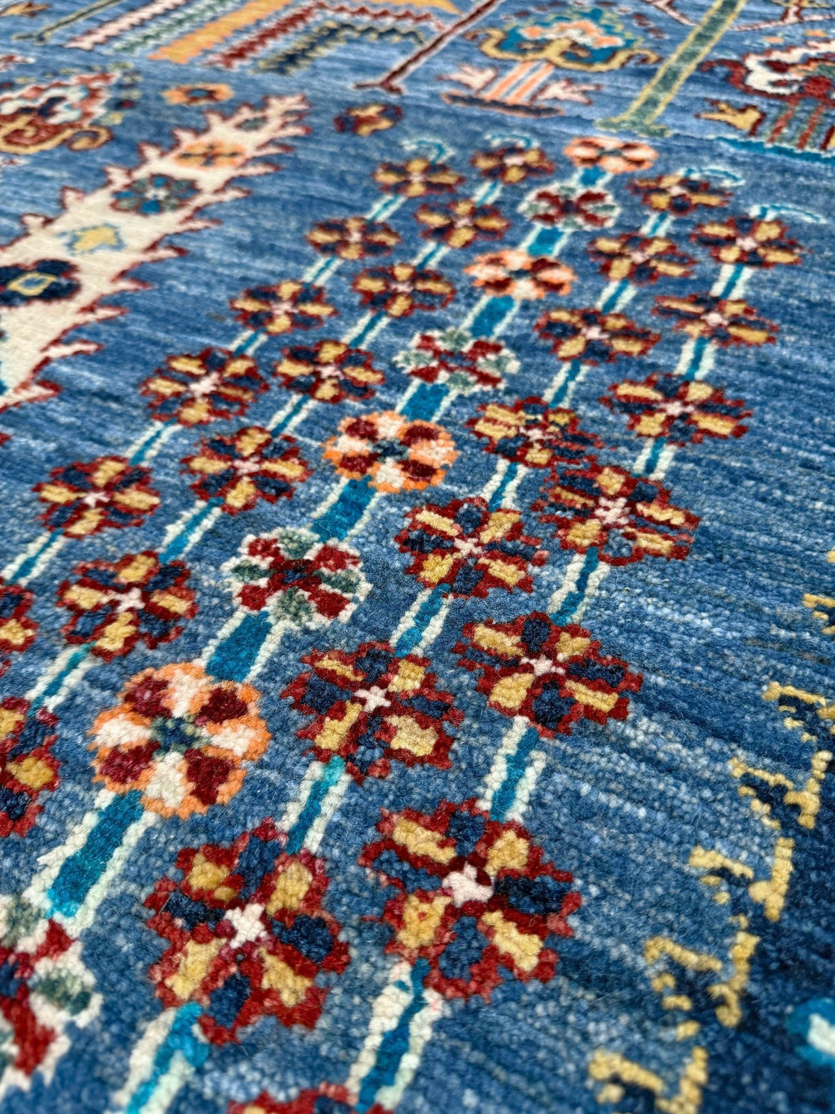 9x12 Tree of Life rug with sky blue field, deep crimson border, cypress trees, floral motifs, handmade wool from Indigo Rugs Burlingame Bay Area.