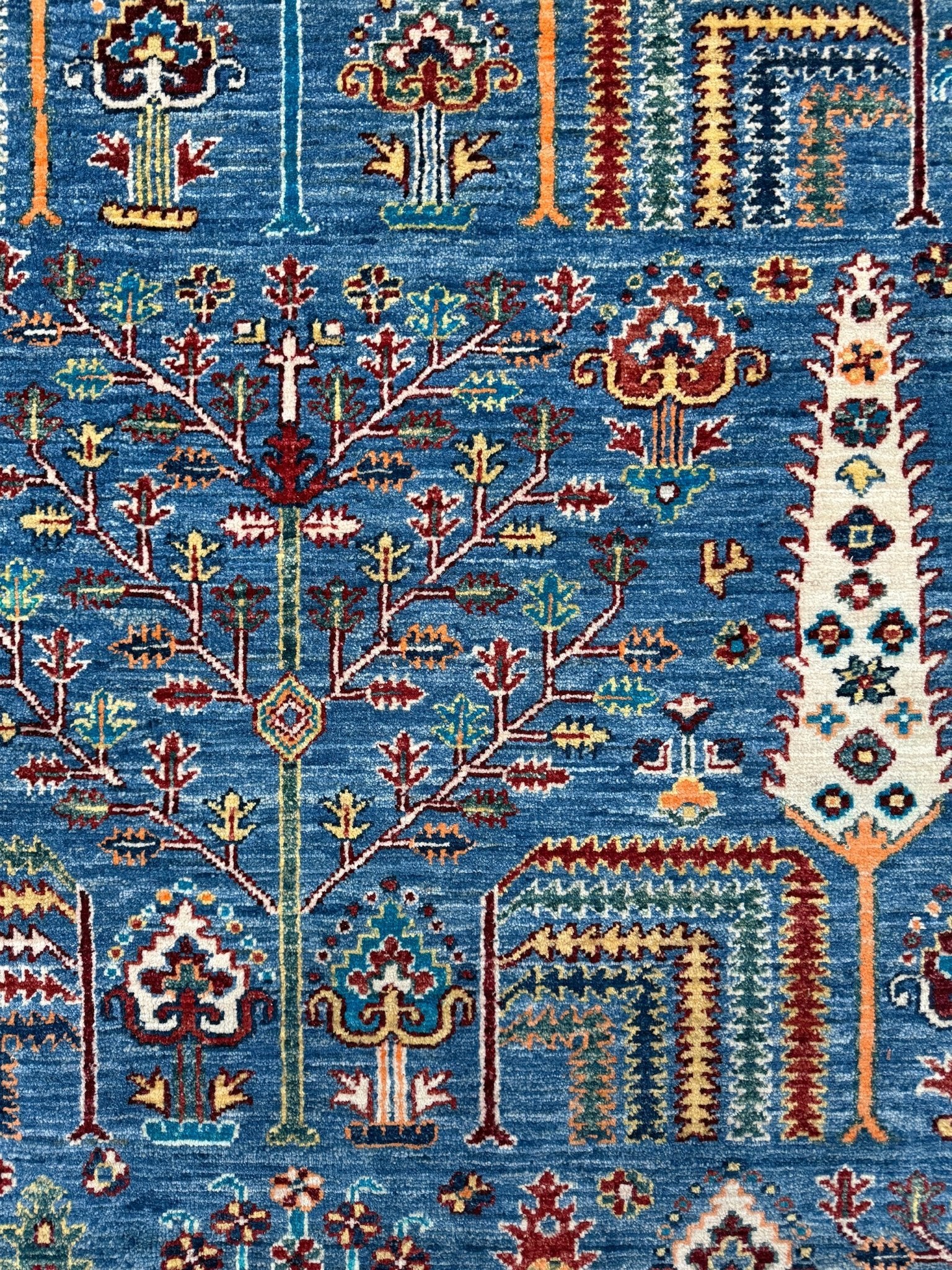 Brand new 9x12 Tree of Life Turkish rug – sky blue with deep crimson red, ivory, and gold accents. Perfect for bedroom, living room, or dining area. High-quality, handmade wool rug from the best rug shop in San Mateo, SF Bay Area. Free shipping available.