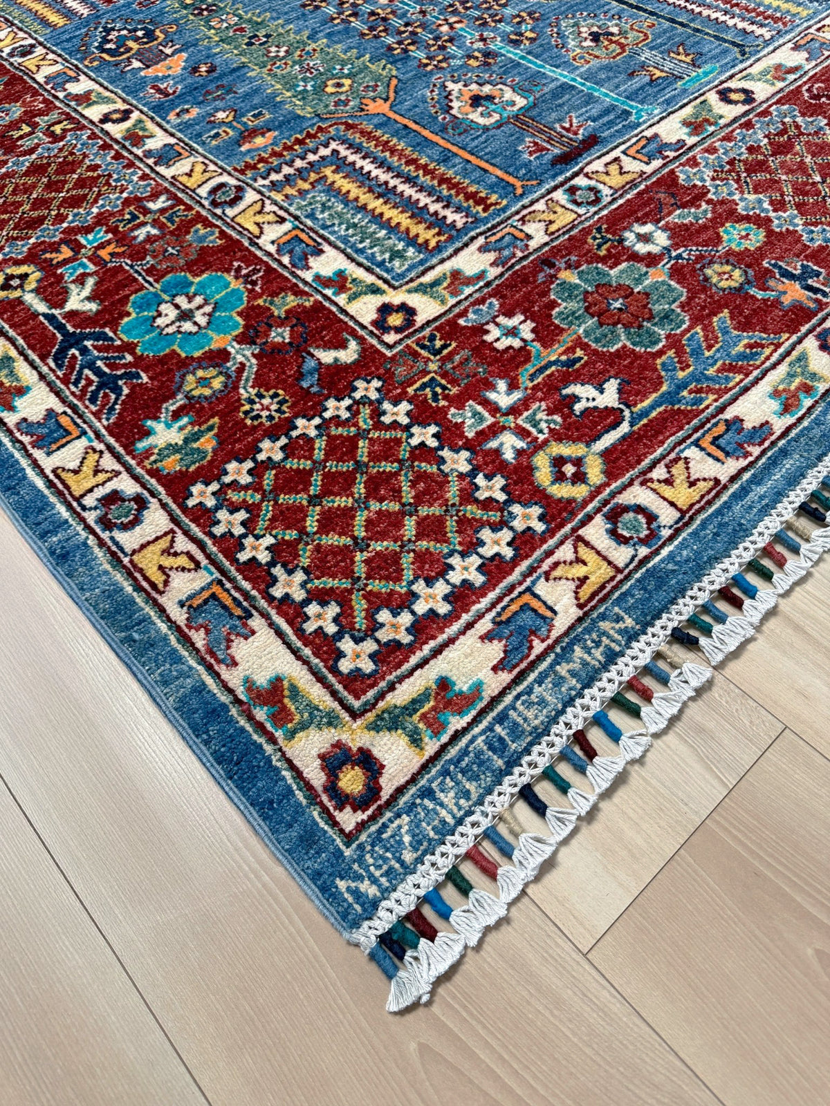 9x12 Tree of Life rug with sky blue field, deep crimson border, cypress trees, floral motifs, handmade wool from Indigo Rugs Burlingame Bay Area.