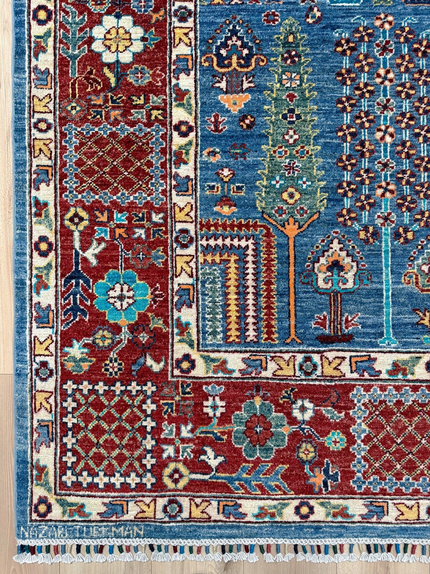 9x12 Tree of Life rug with sky blue field, deep crimson border, cypress trees, floral motifs, handmade wool from Indigo Rugs Burlingame Bay Area.