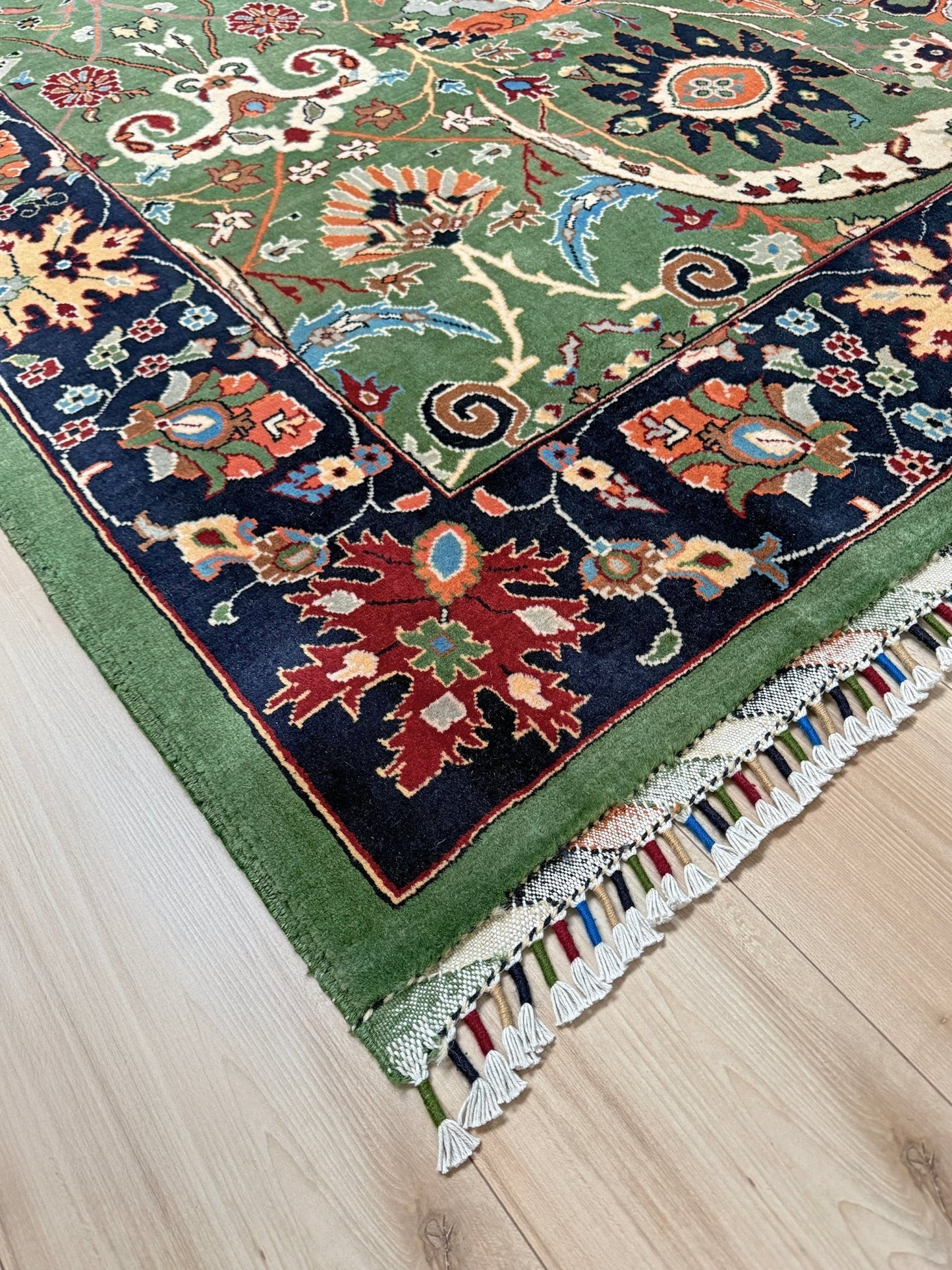 Brand new 9x12 Persian sickle leaf rug with verdant green, navy, and crimson hues, available at the best rug shop in San Mateo, SF Bay Area. Handwoven with intricate floral and vine patterns, perfect for a bedroom, living room, or dining space. High-quality wool rug with rich character and timeless elegance. Free shipping available.